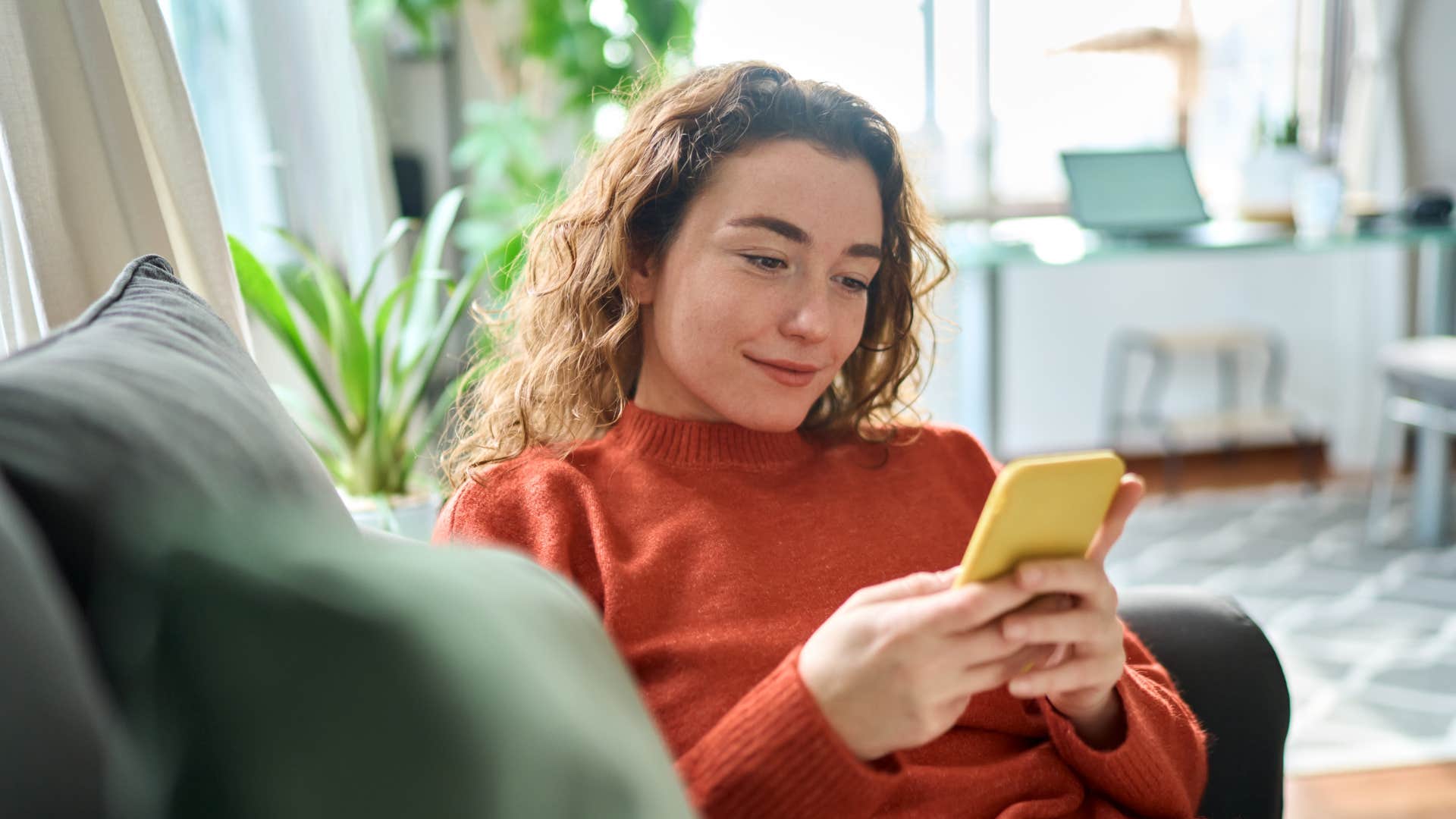 happy woman scrolling through social media