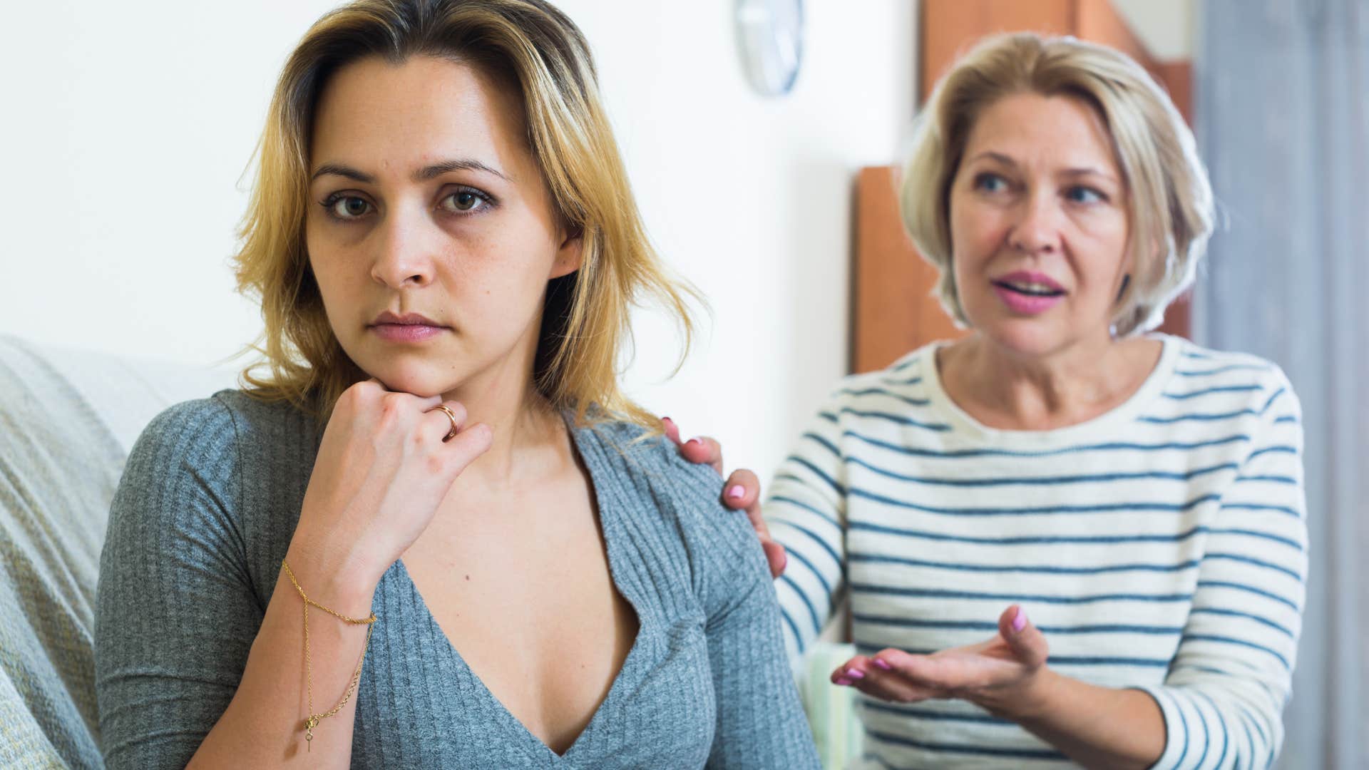 woman listening to her mom yell at her about her life choices