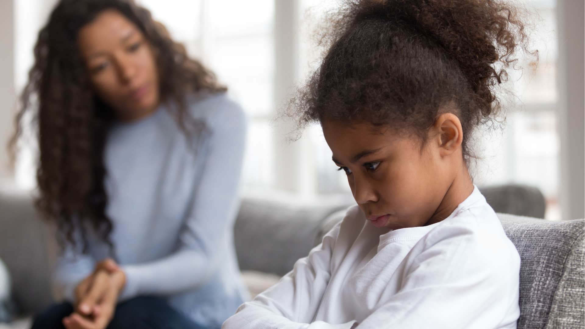 upset girl who doesn't accept no as an answer turned away from her mom