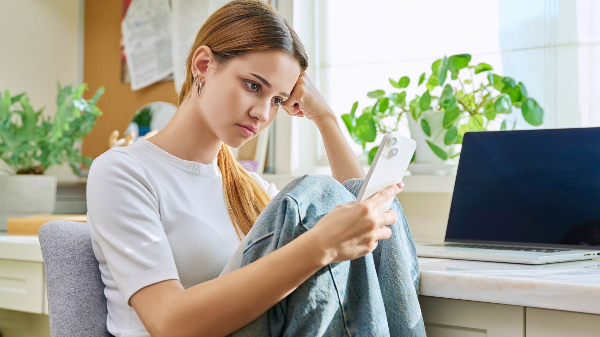 teenager with unrealistic expectations for life looking at her phone