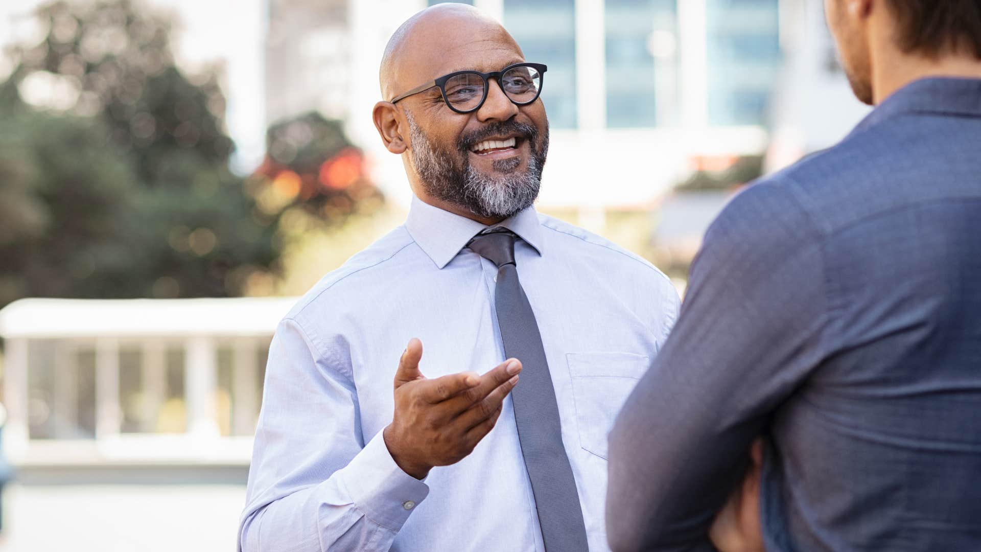 wealthy man in professional clothing talking to a peer