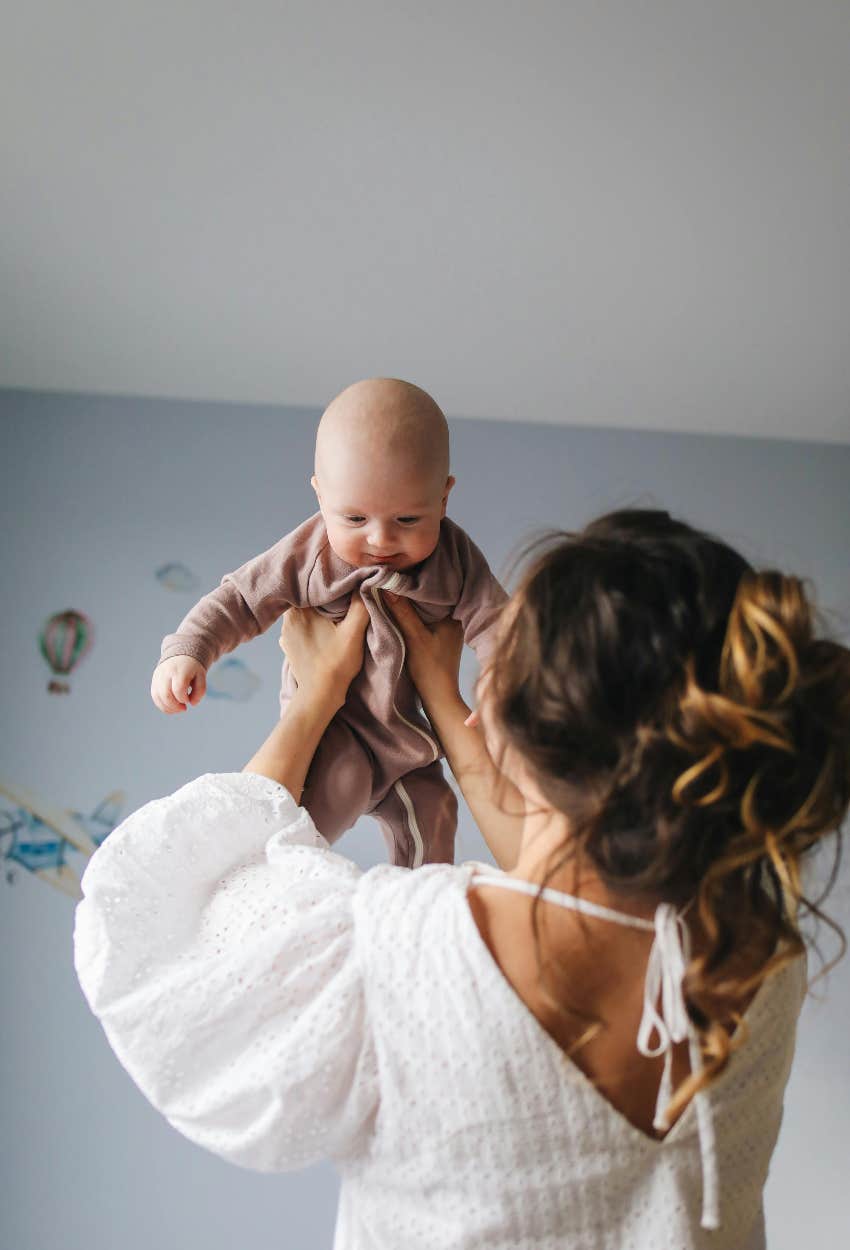 mom holding her baby boy parenting trick secret happier baby