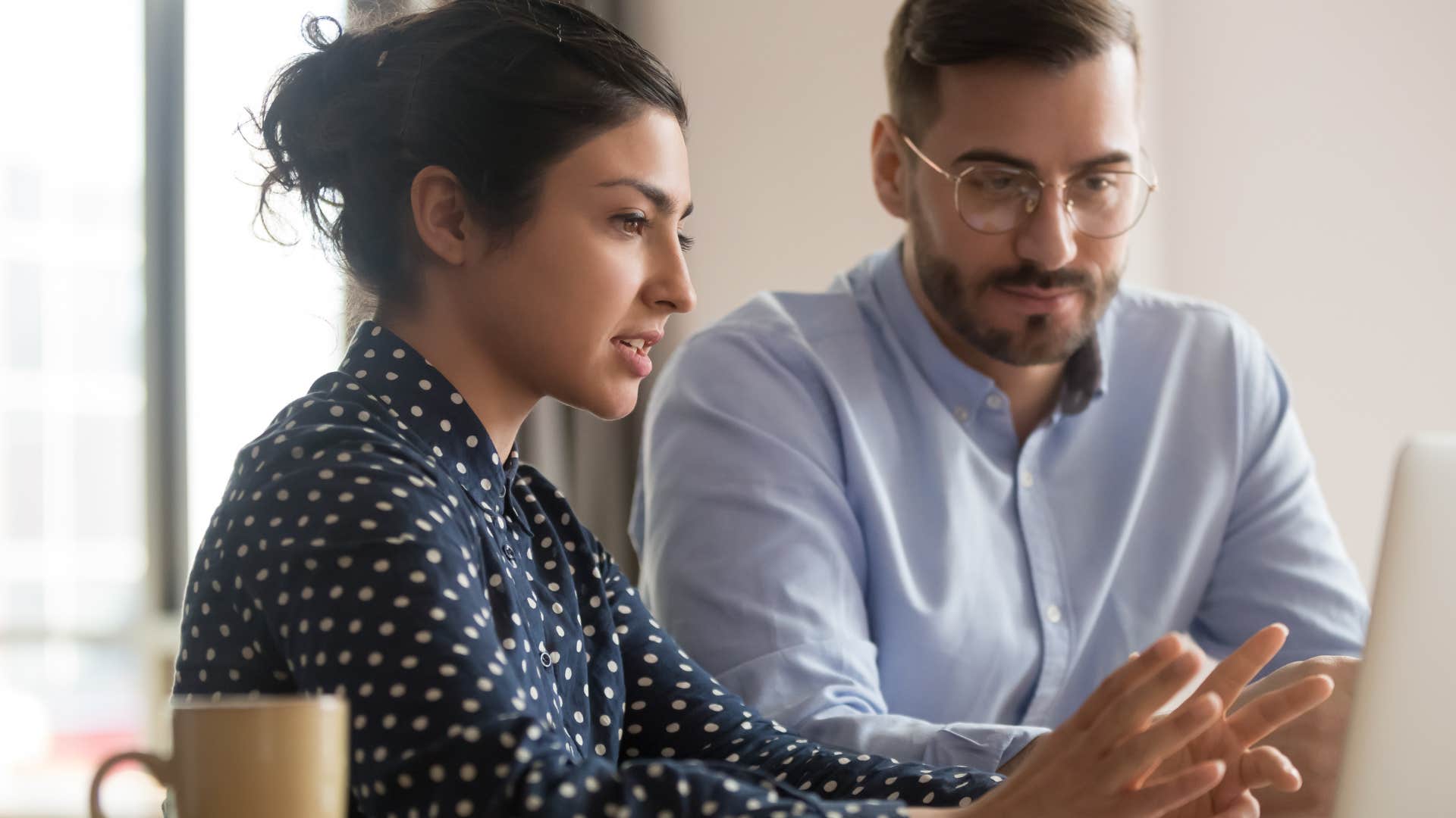 Woman avoiding small talk next to her co-worker.