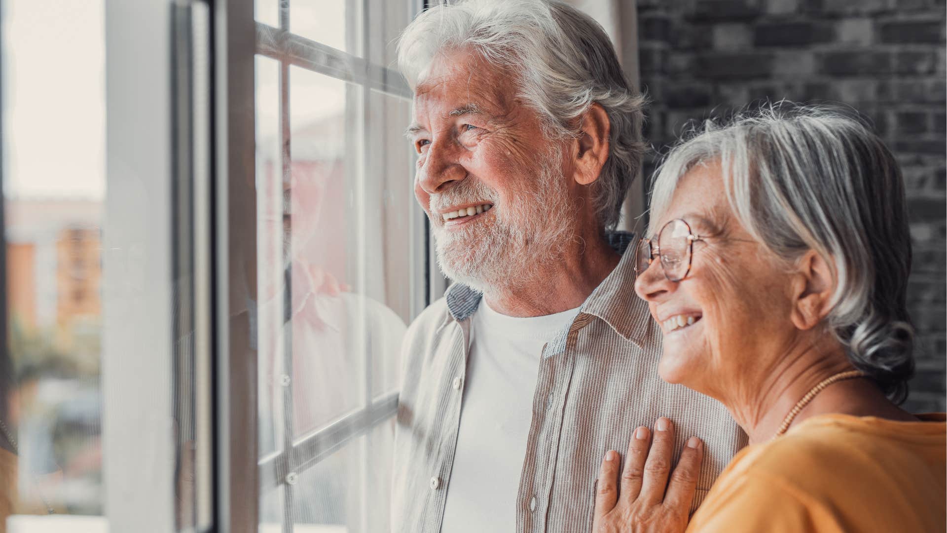 couple smiling in their living room in the natural light