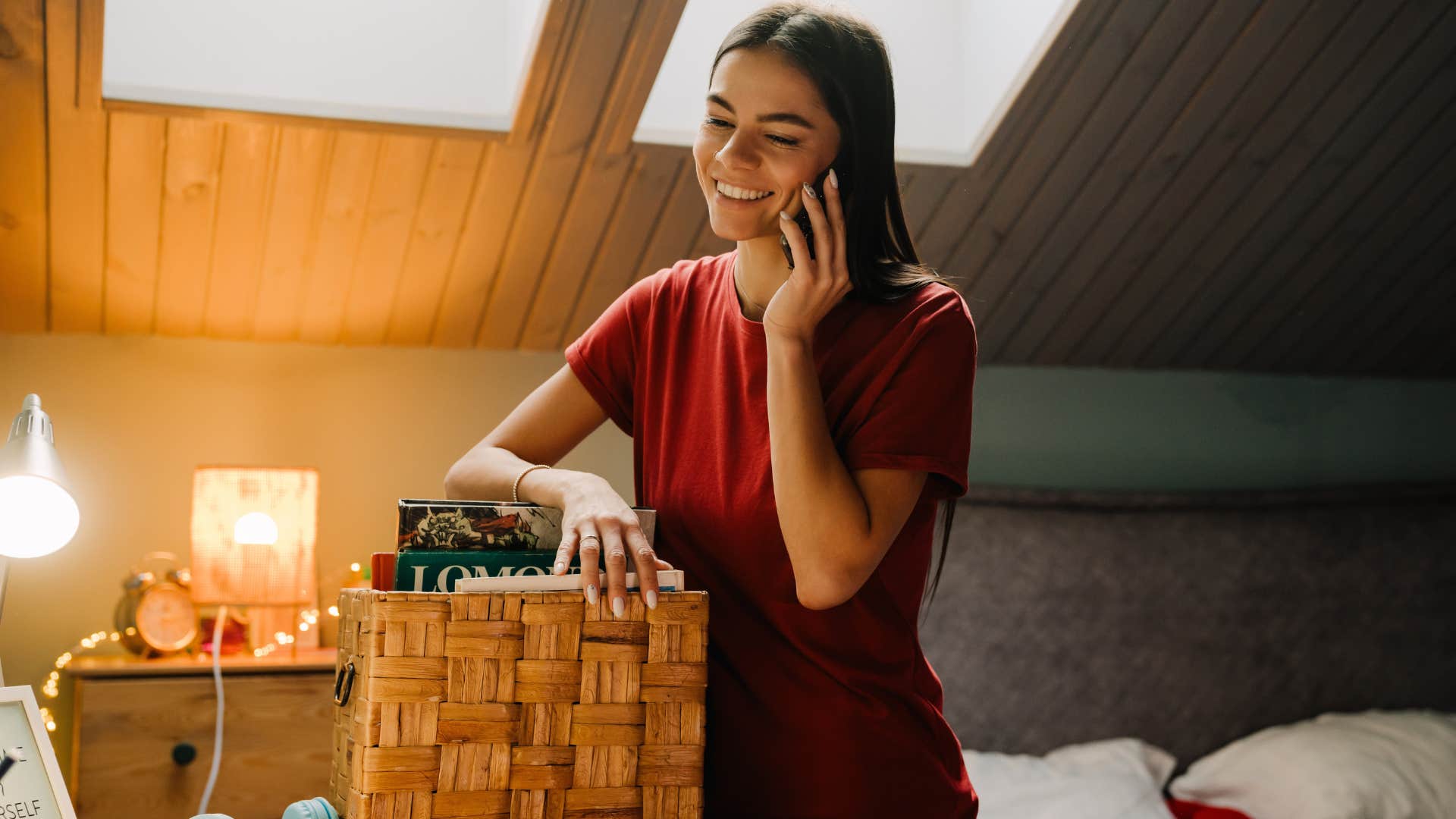 woman on the phone after cleaning under her bed