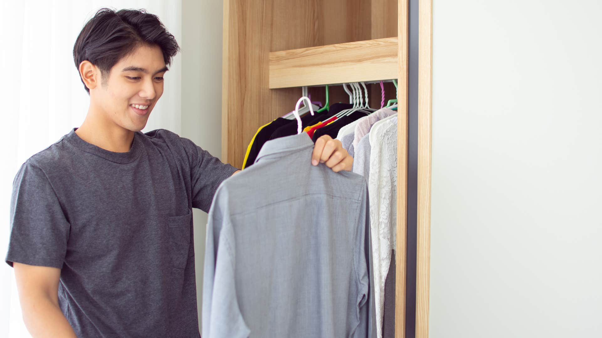 man picking out his outfit for work