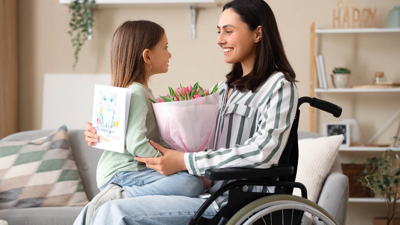 Toddler Builds A Bear In A Wheelchair Because It Looks Just Like Her Mom mom in wheelchair holding her daughter in her lap