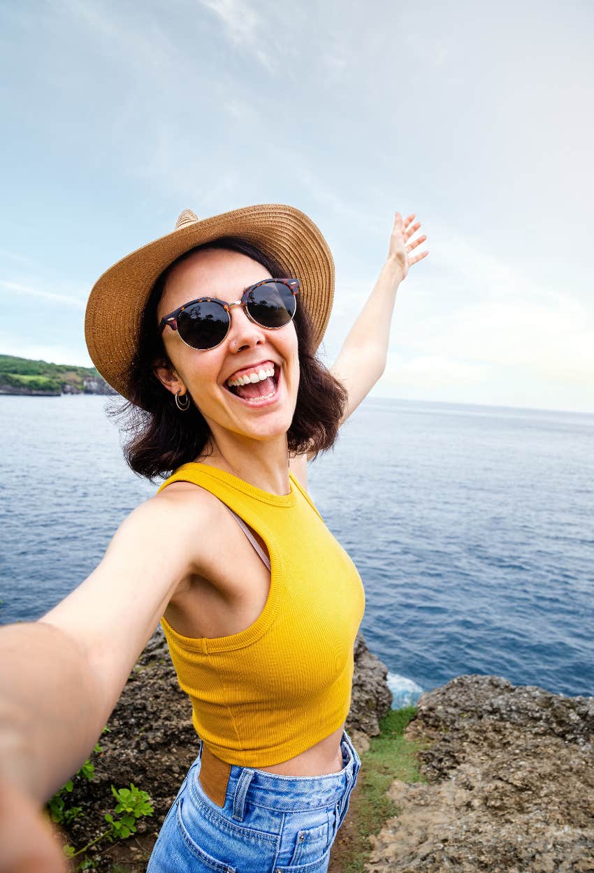 Tourist taking a selfie careless damages art