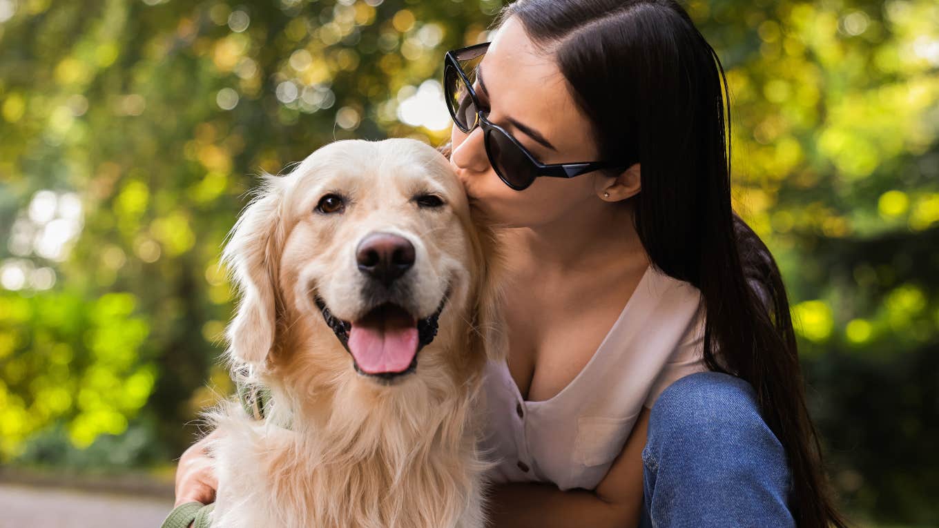 Types of Dogs And The Special Kind of Love They Bring Into Their Person's Life woman kissing her cute dog