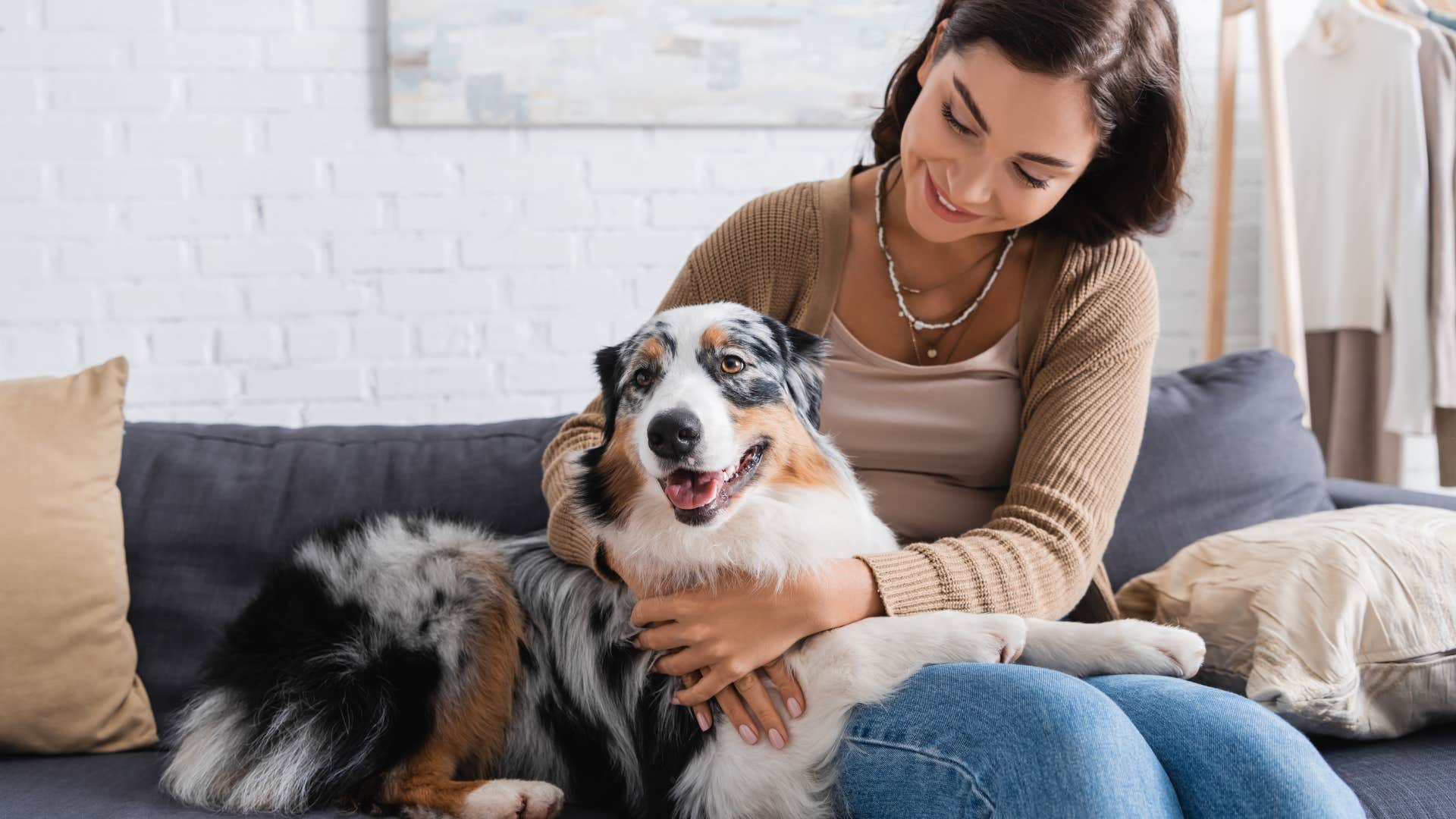 woman sitting with her dog on the couch