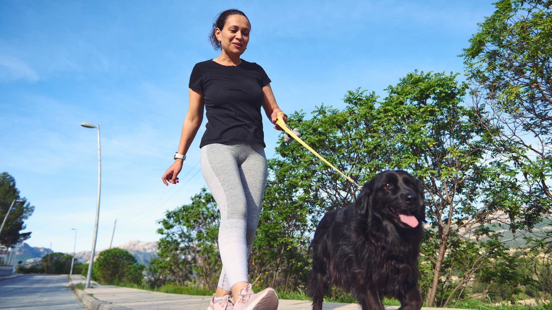 happy woman walking her dog
