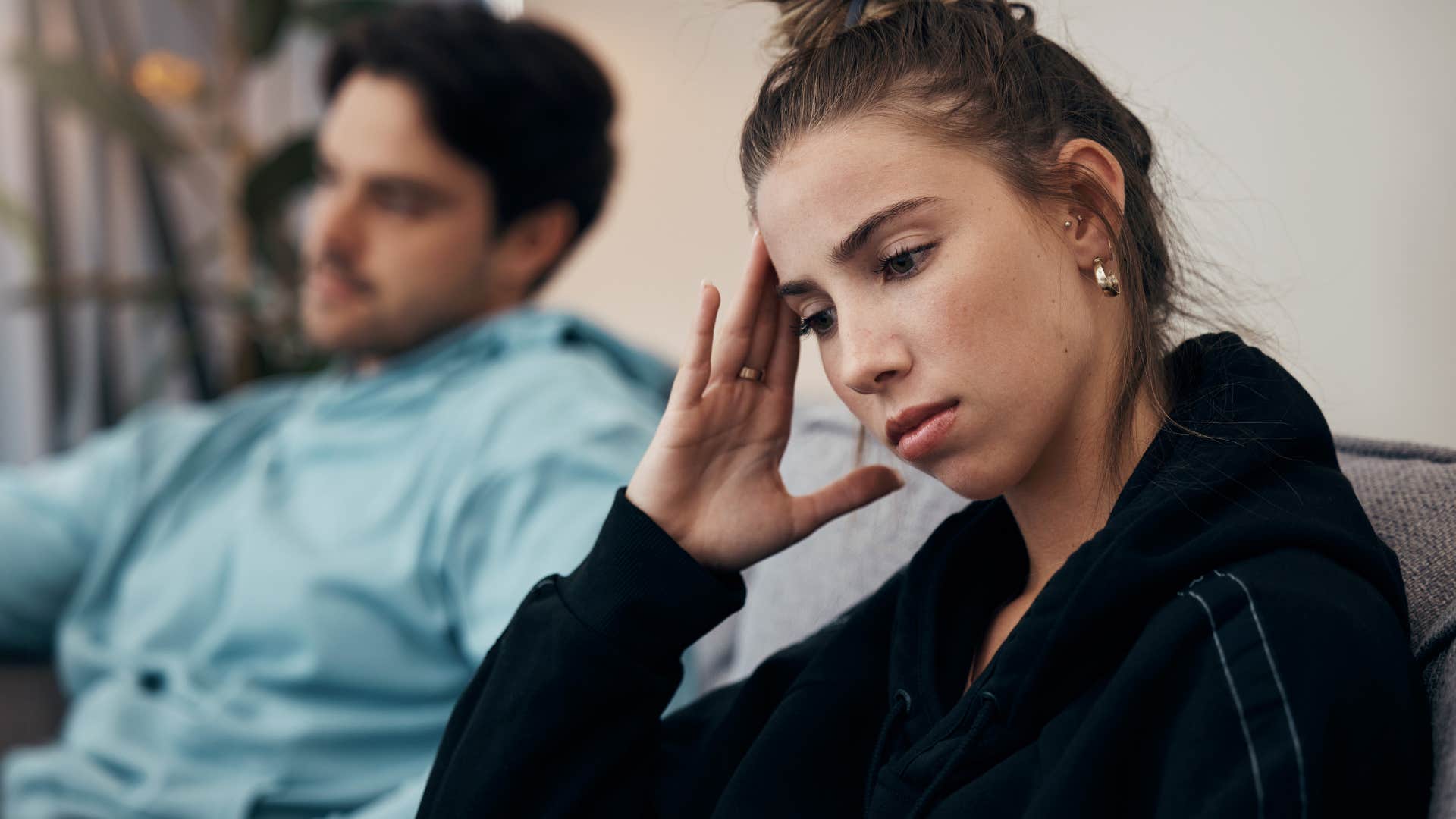 woman disliking conflict sitting next to her husband