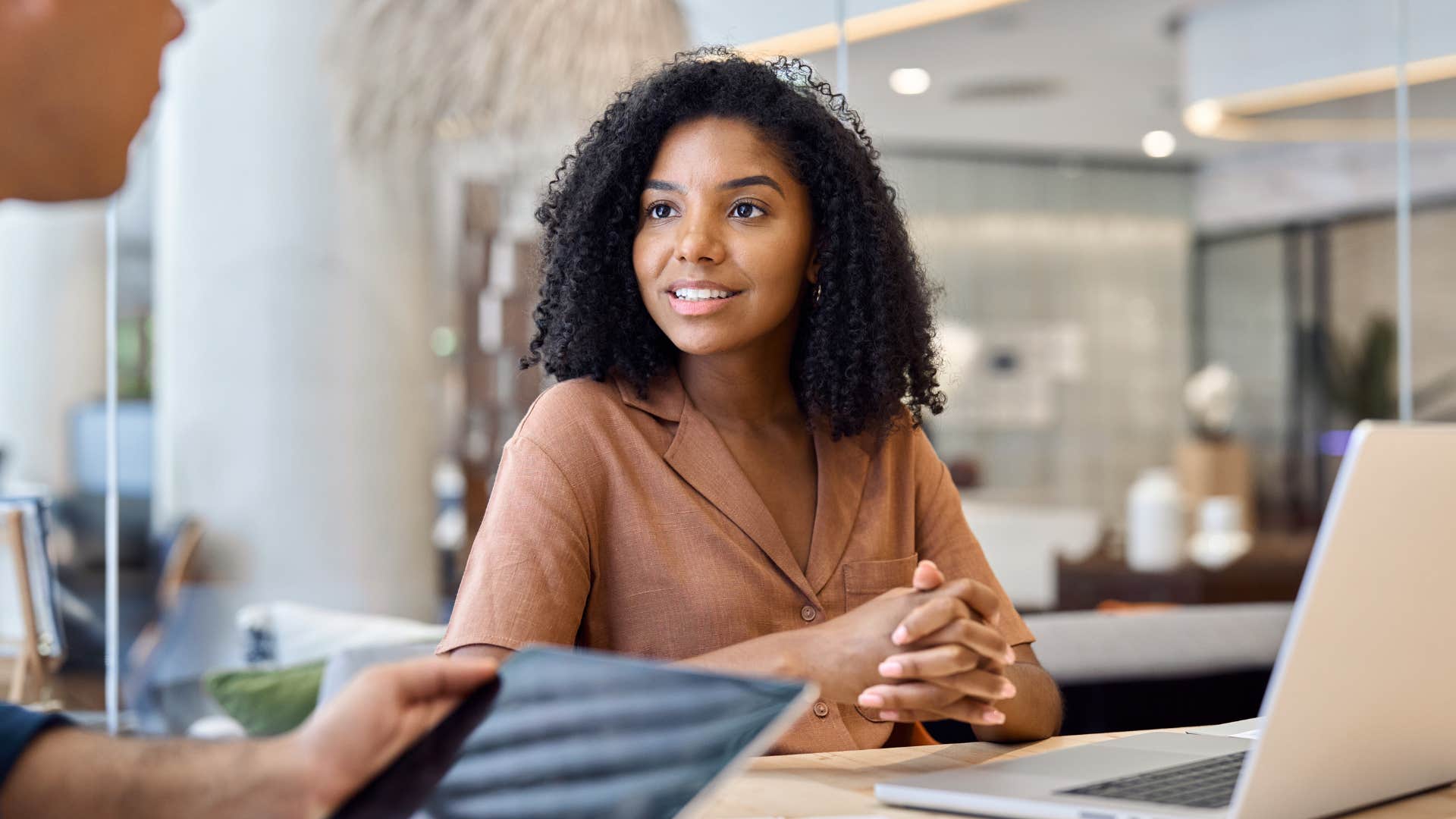 woman listening to colleague at work