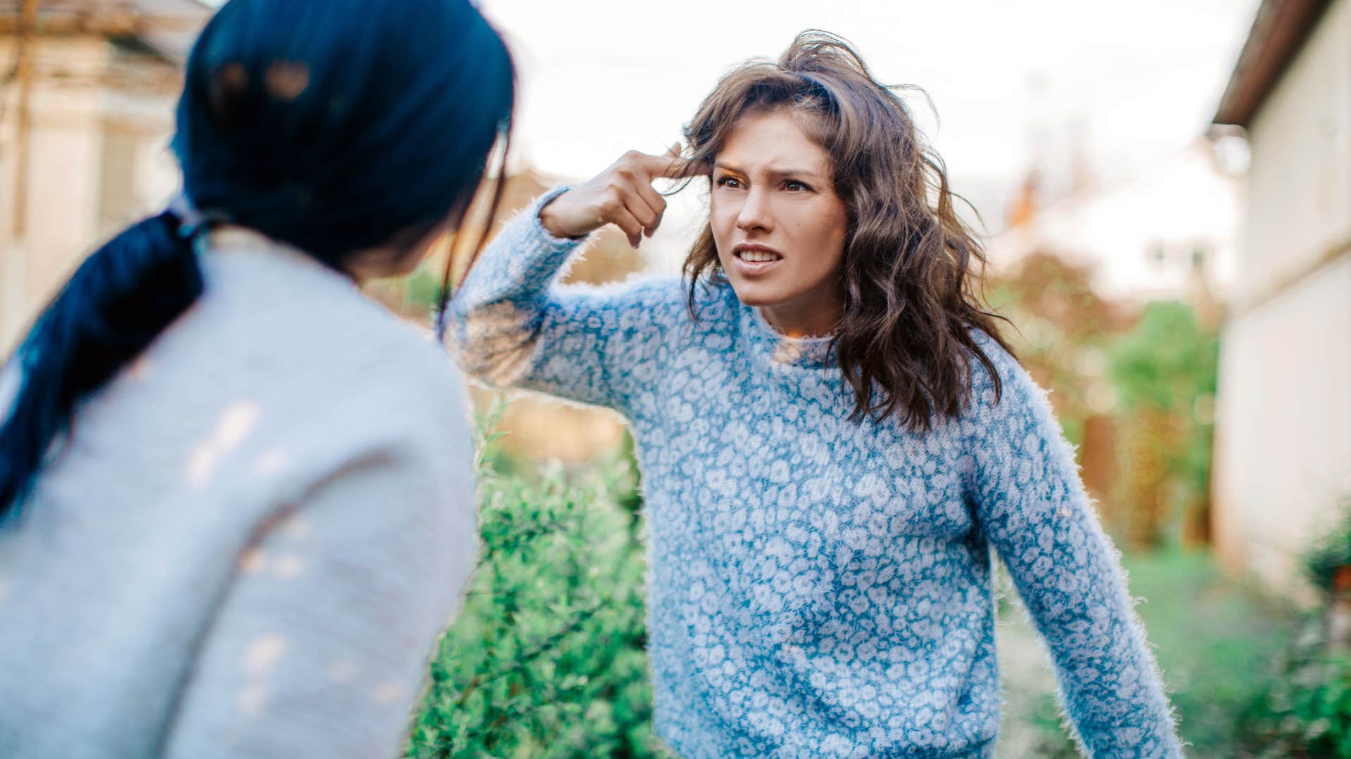 woman who can't control her emotions yelling at friend