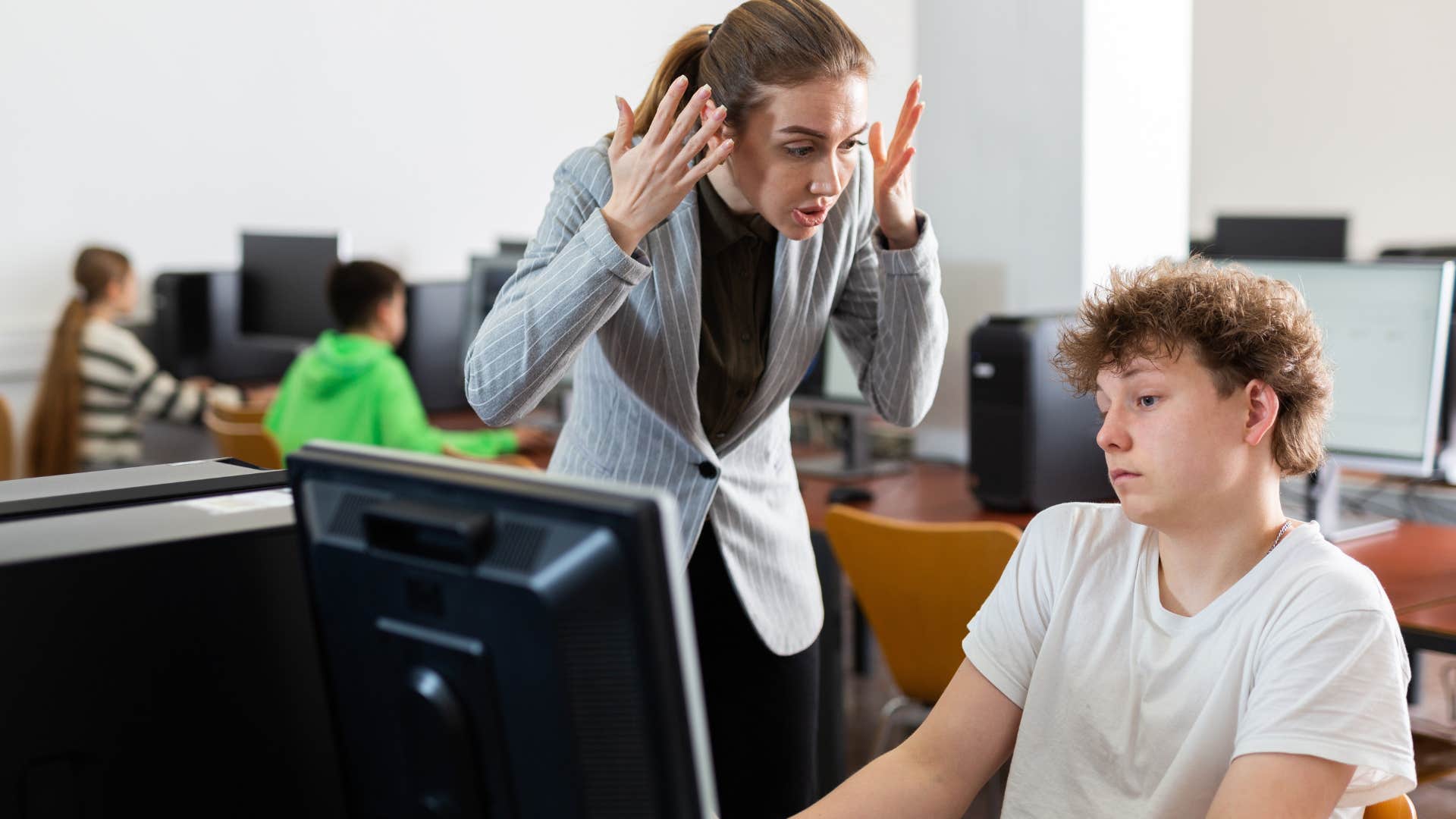 Woman arguing with a teenage boy who pits students and teachers against each other.