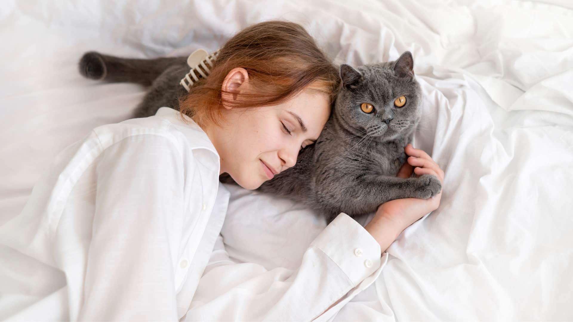 a woman takes a power nap next to her cat but ends up sleeping longer than she should