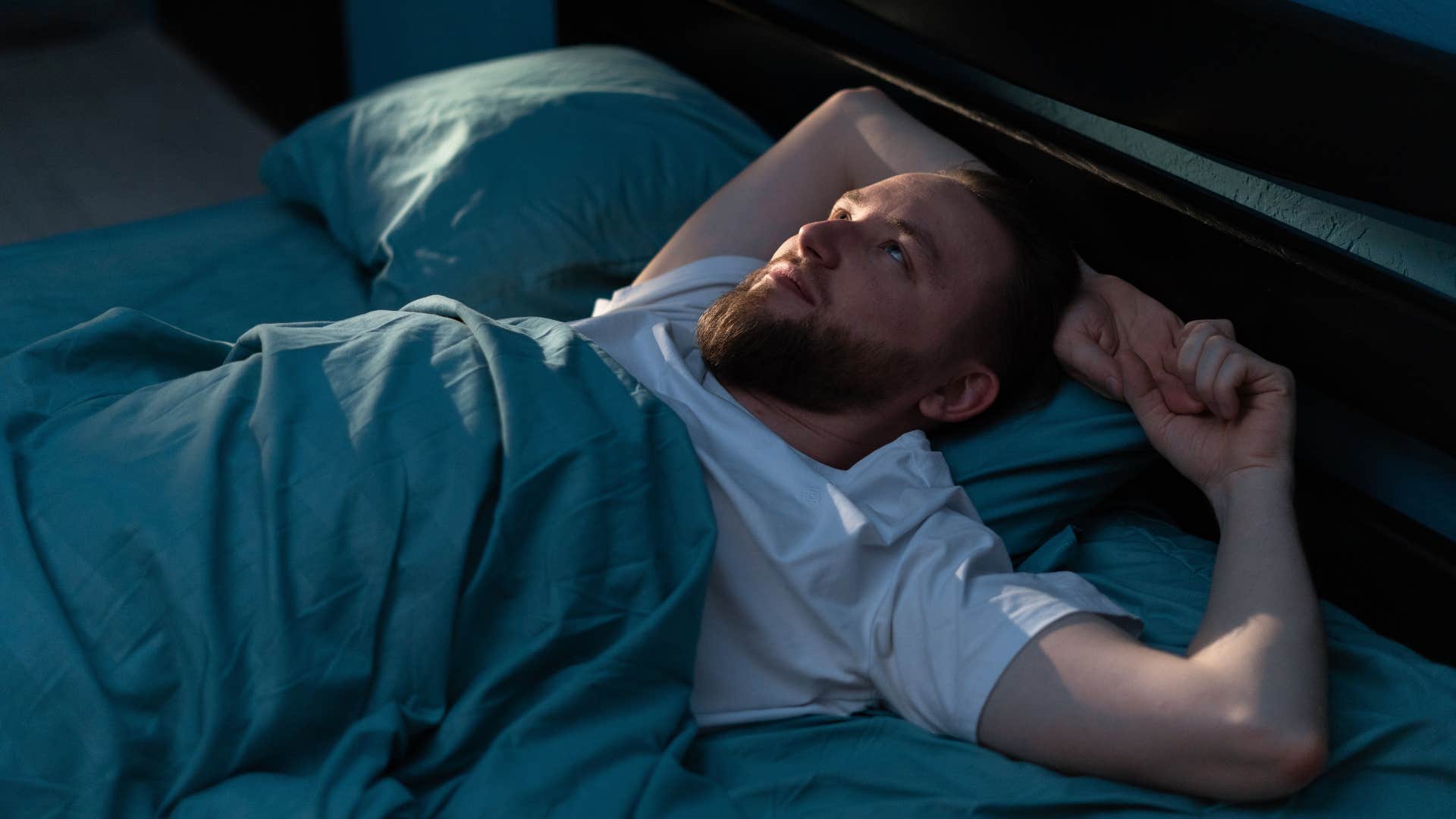 a man tries to stay still so that he can fall asleep faster