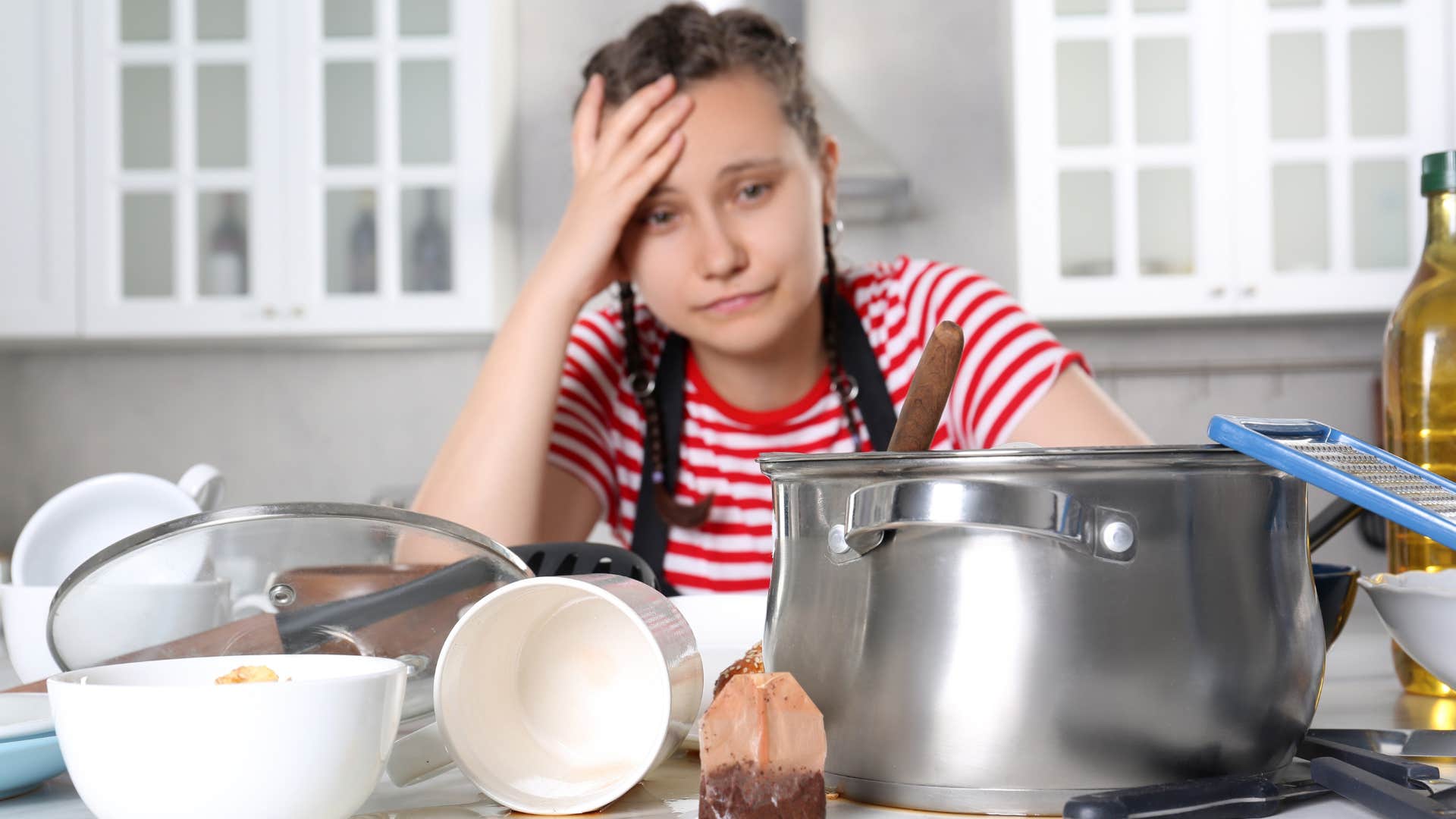 a woman gets overwhelmed with the mess in the kitchen and waits until the morning to do them