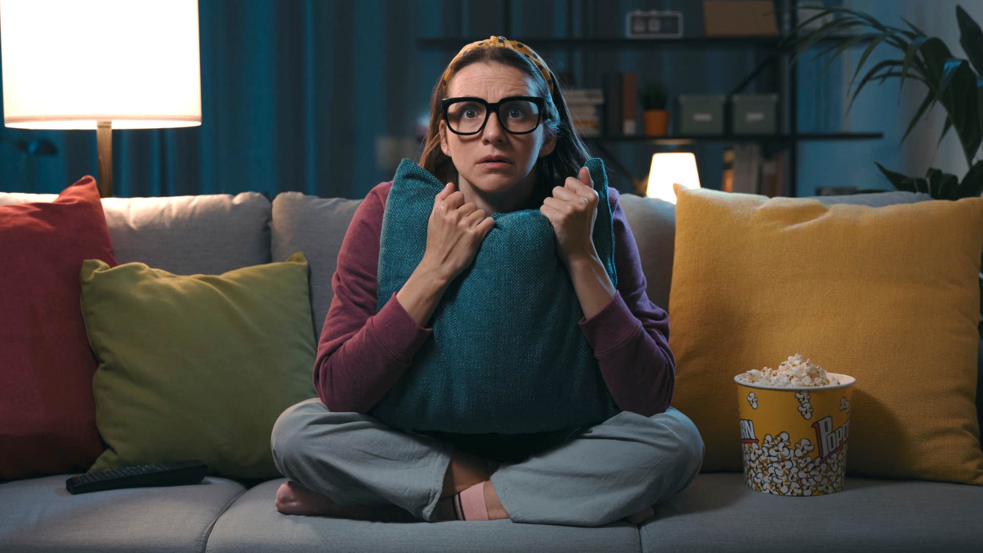 a woman watches a scary movie before bed and regrets it