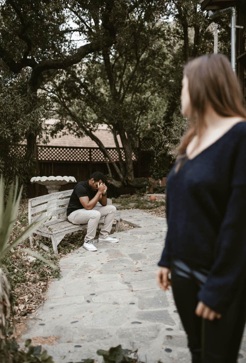woman looking back at man asking why she wants him back