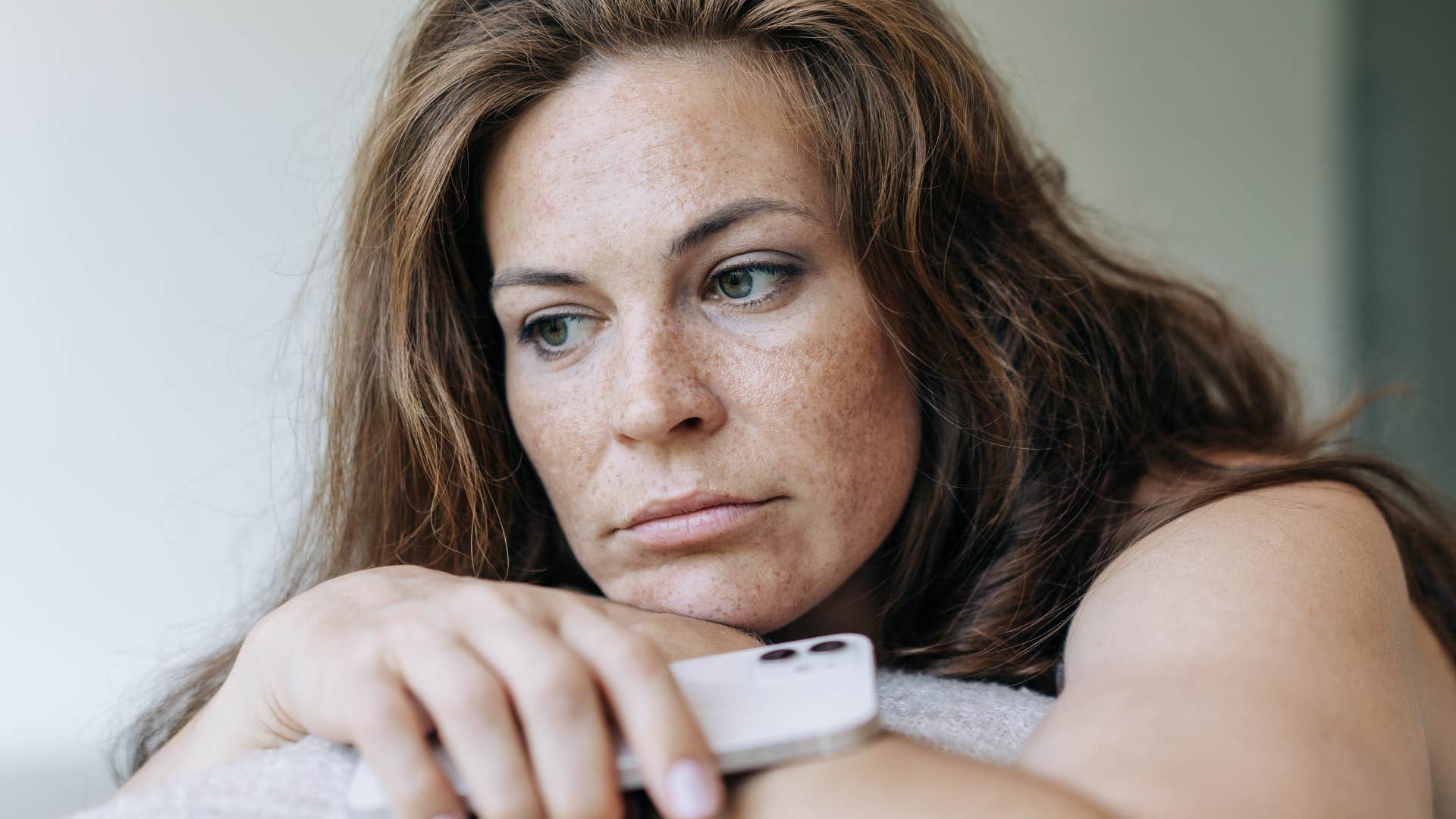 Woman who's experiencing more anxiety looking outside.