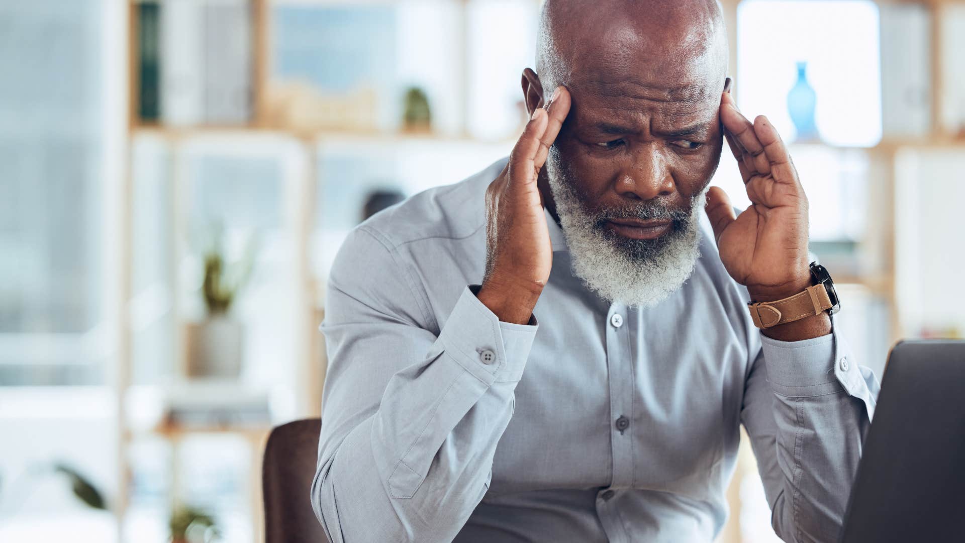 stressed out boss holding his temples