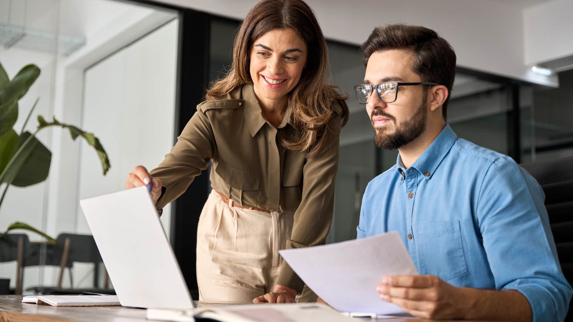 boss hovering over employee trying to work 