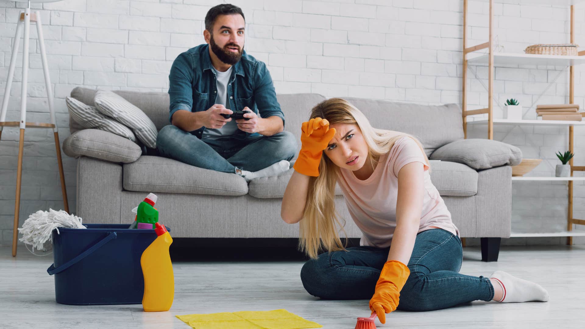 a woman is fed up with cleaning while her husband escapes to his video game