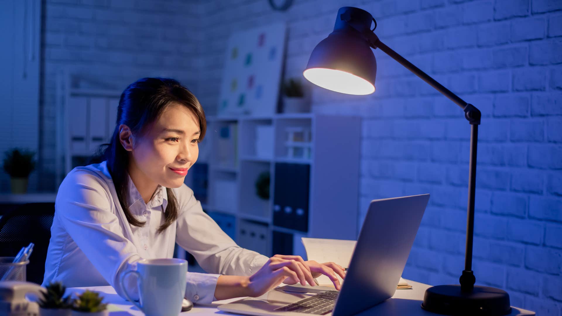 woman working hard on her laptop at night