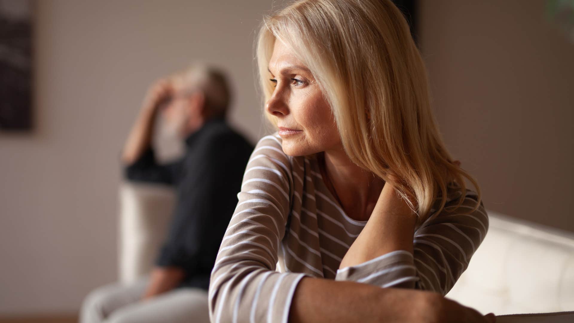 Woman thinking about inconsistency while ignoring her partner