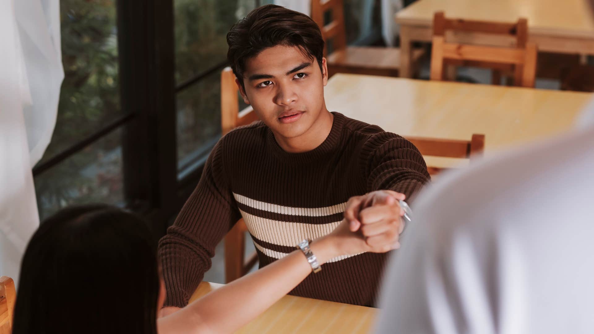 Man being rude to people in a restaurant with his partner
