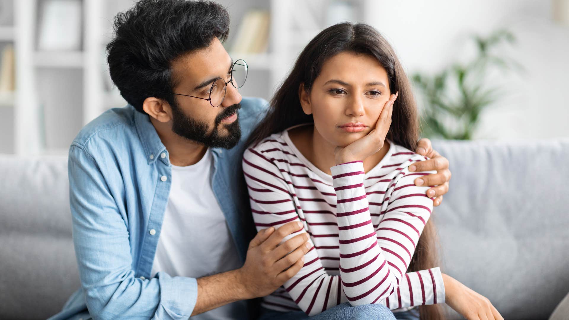 Man making excuses while comforting his partner