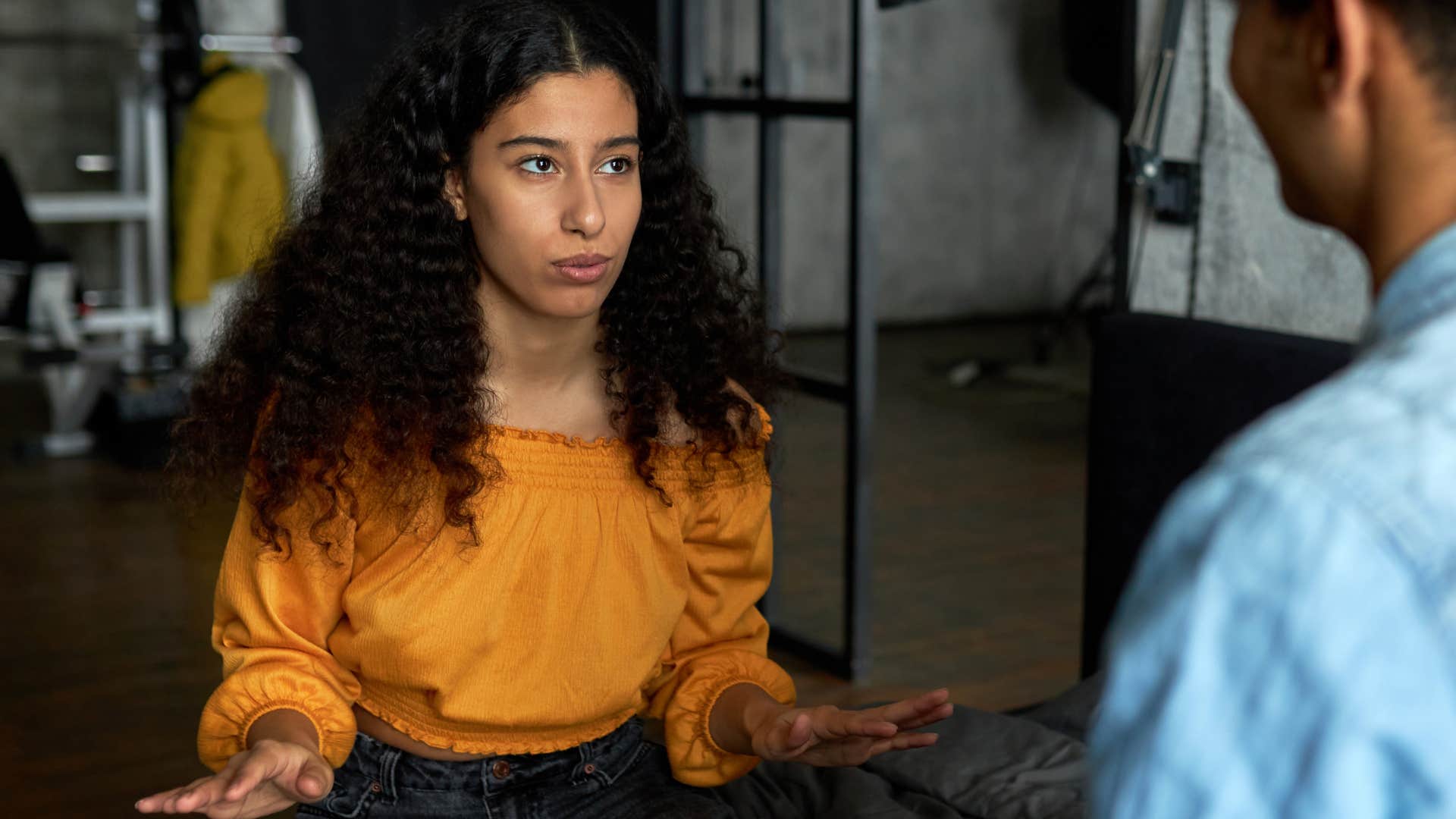 Woman whose words are not matching actions talking to her partner.