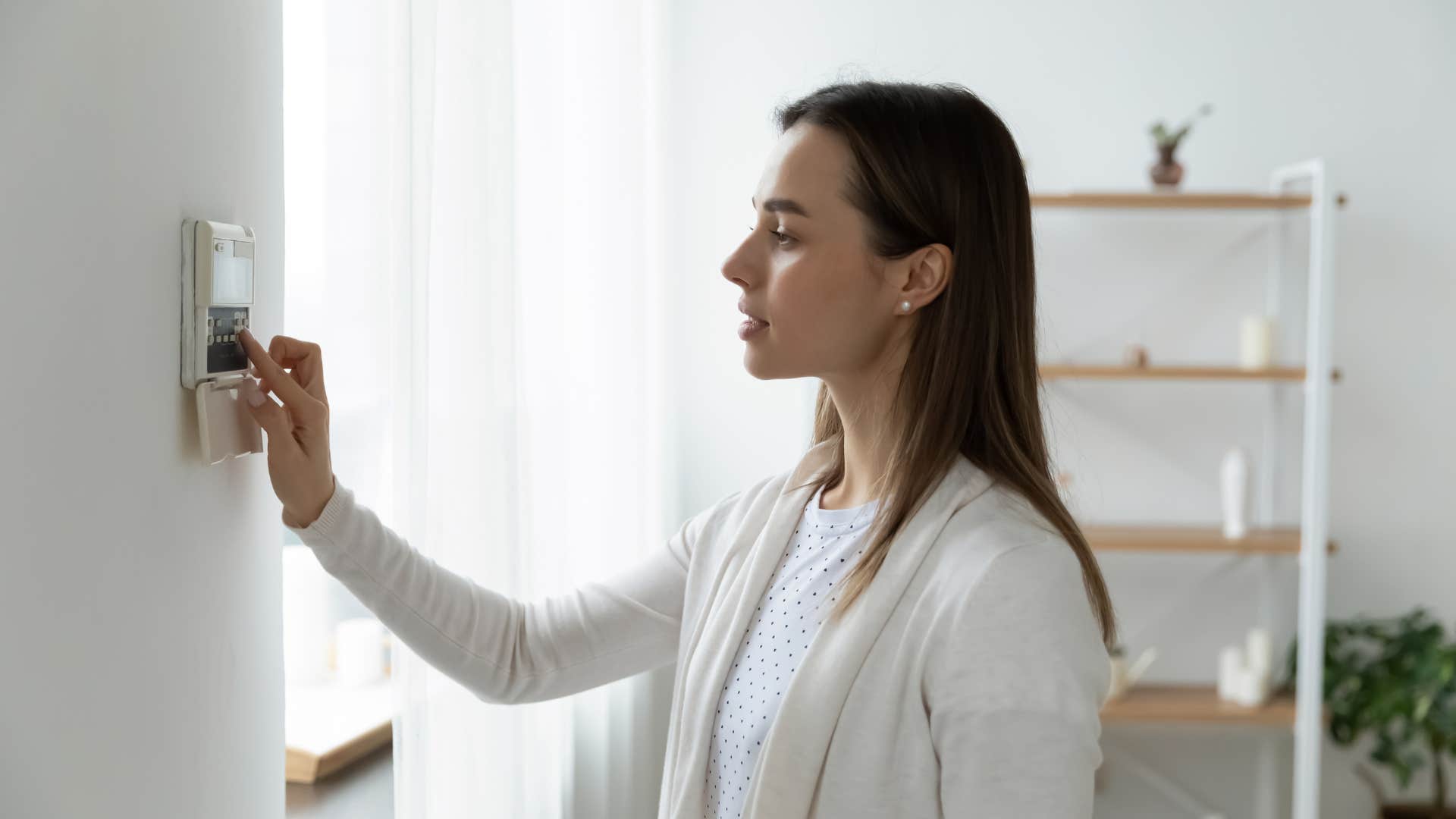 woman turning off lights at home