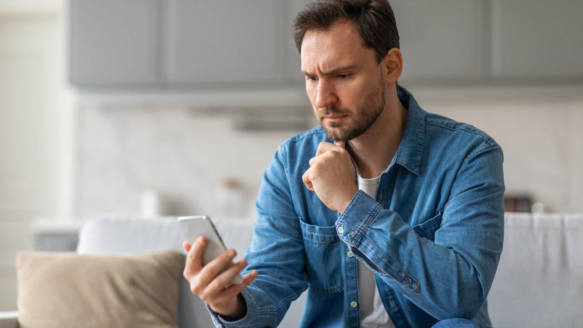 serious man looking at his phone