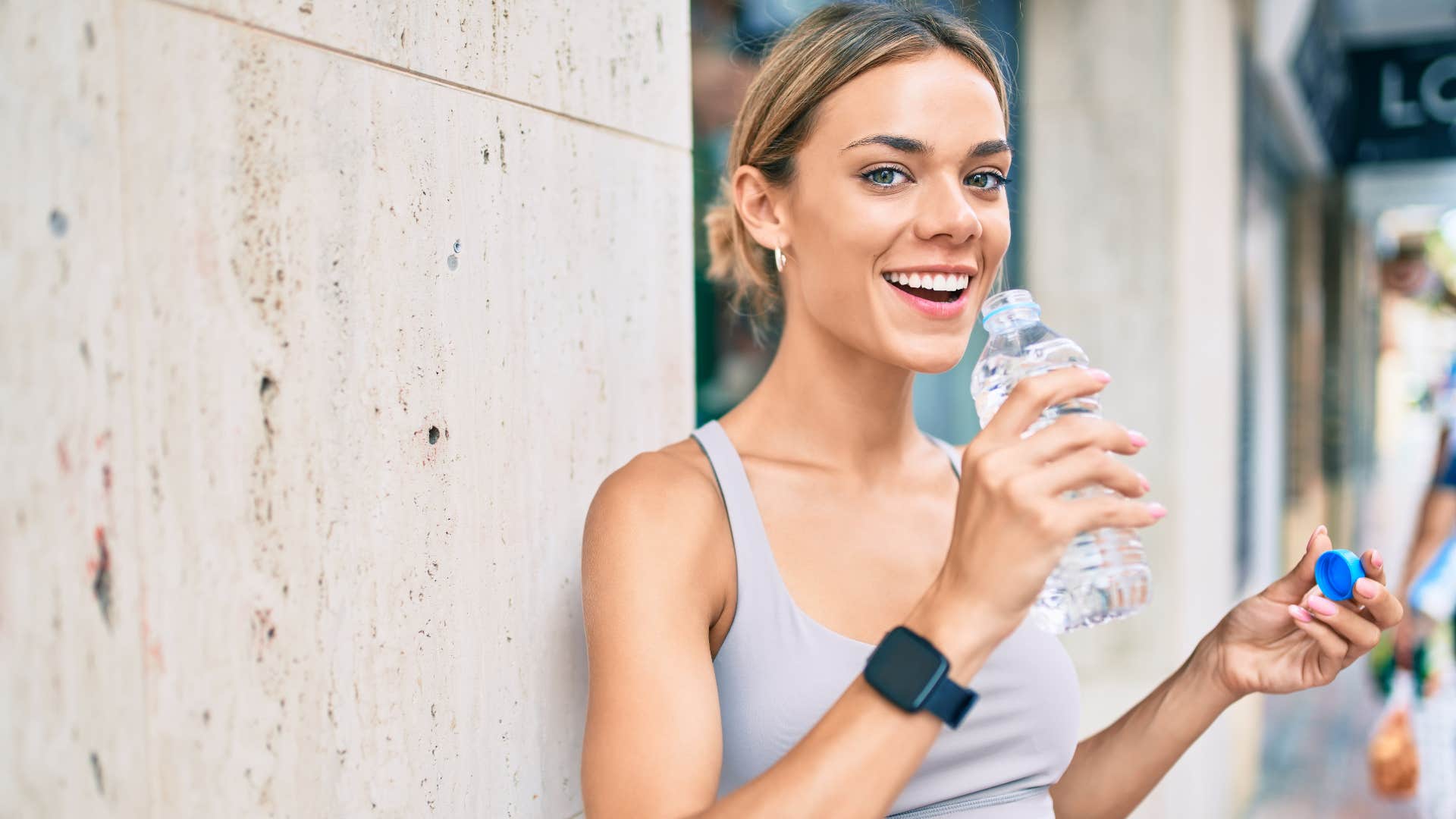 woman drinking bottled water