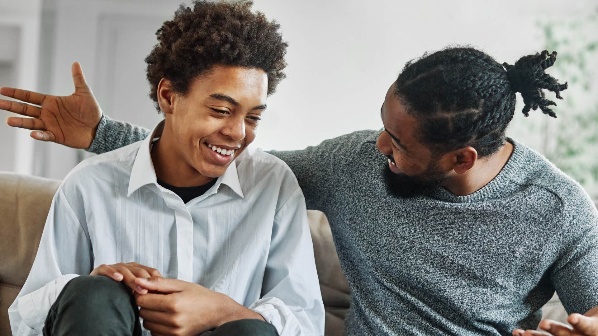 man saying bless you to his young son
