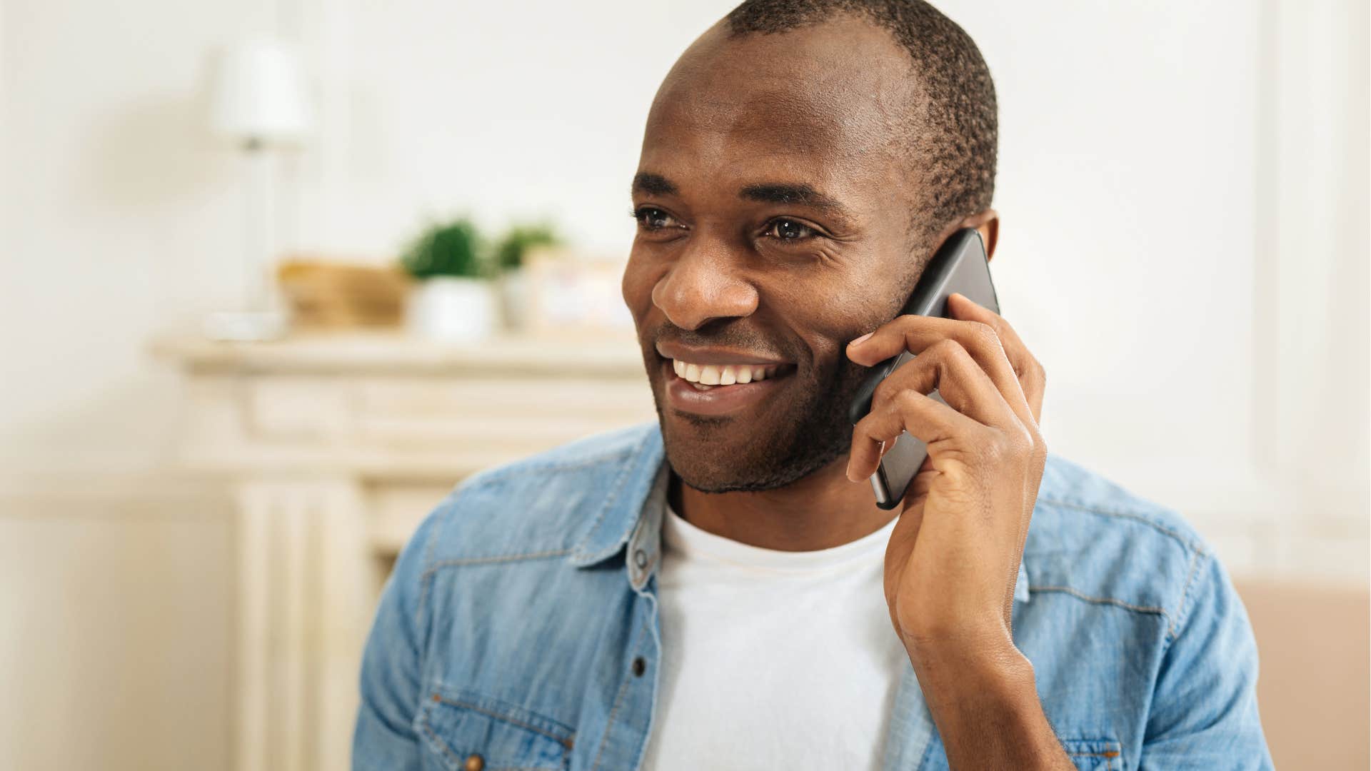 man smiling and saying I don't know but I'll find out while on phone