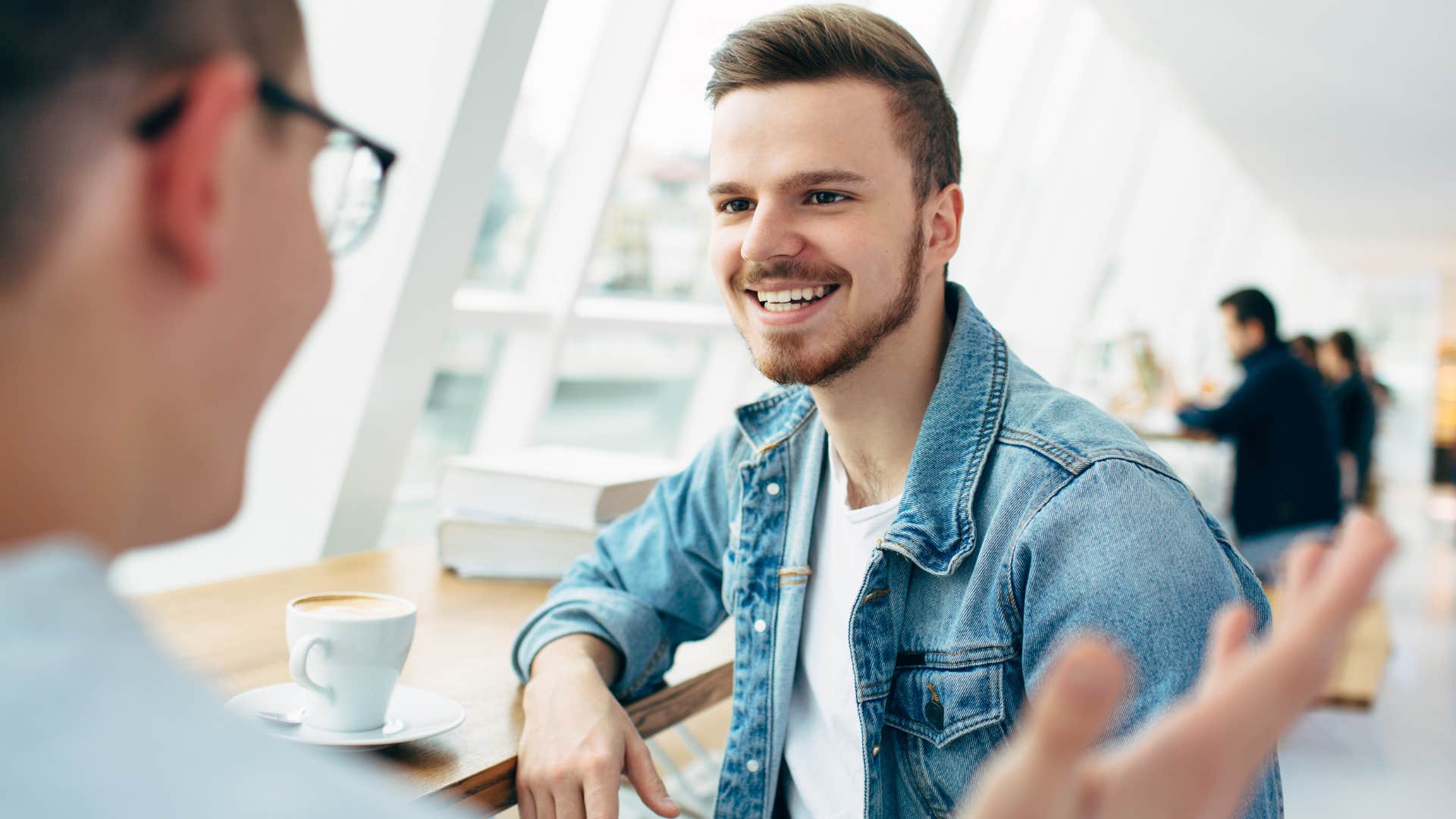 man apologizing to friend for interrupting