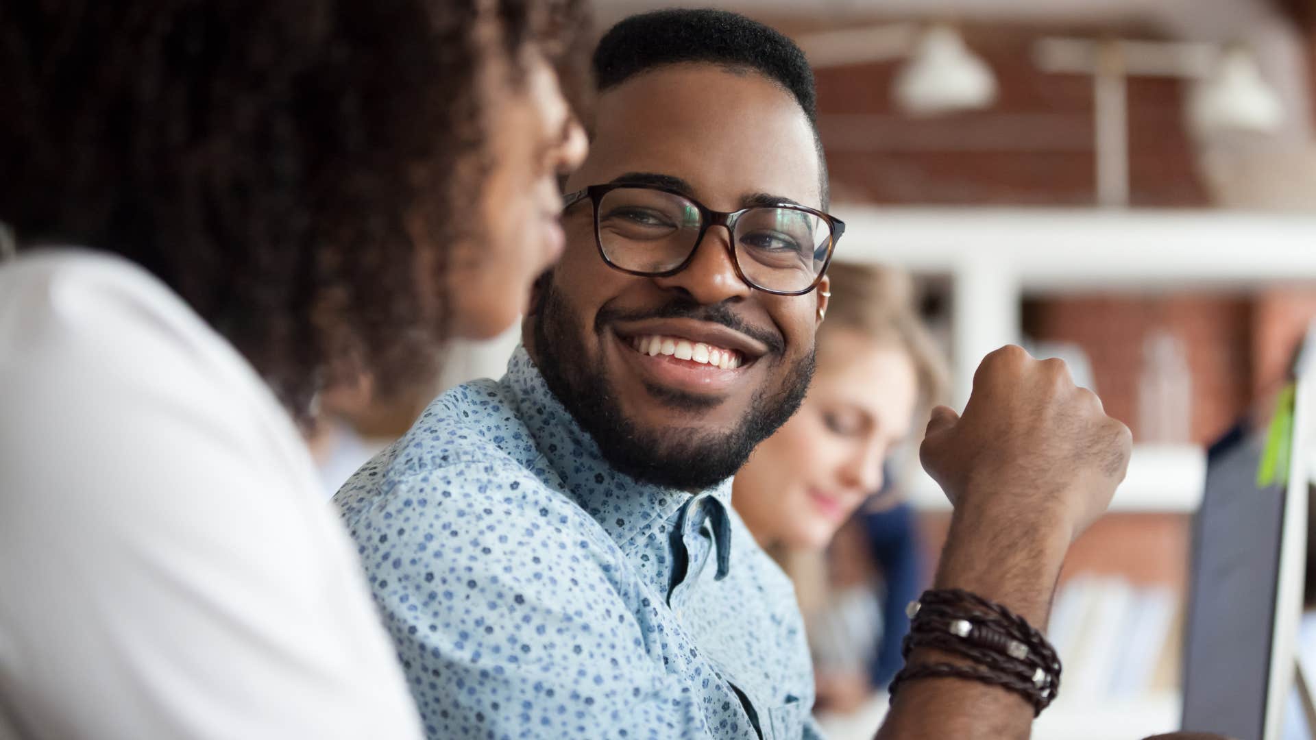 man smiling asking remind me of your name to a co-worker