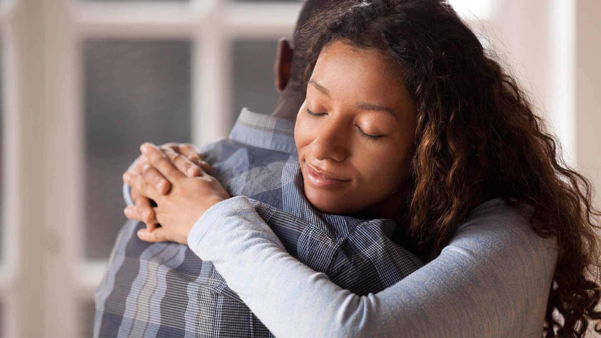 sincere woman hugging her partner and apologizing