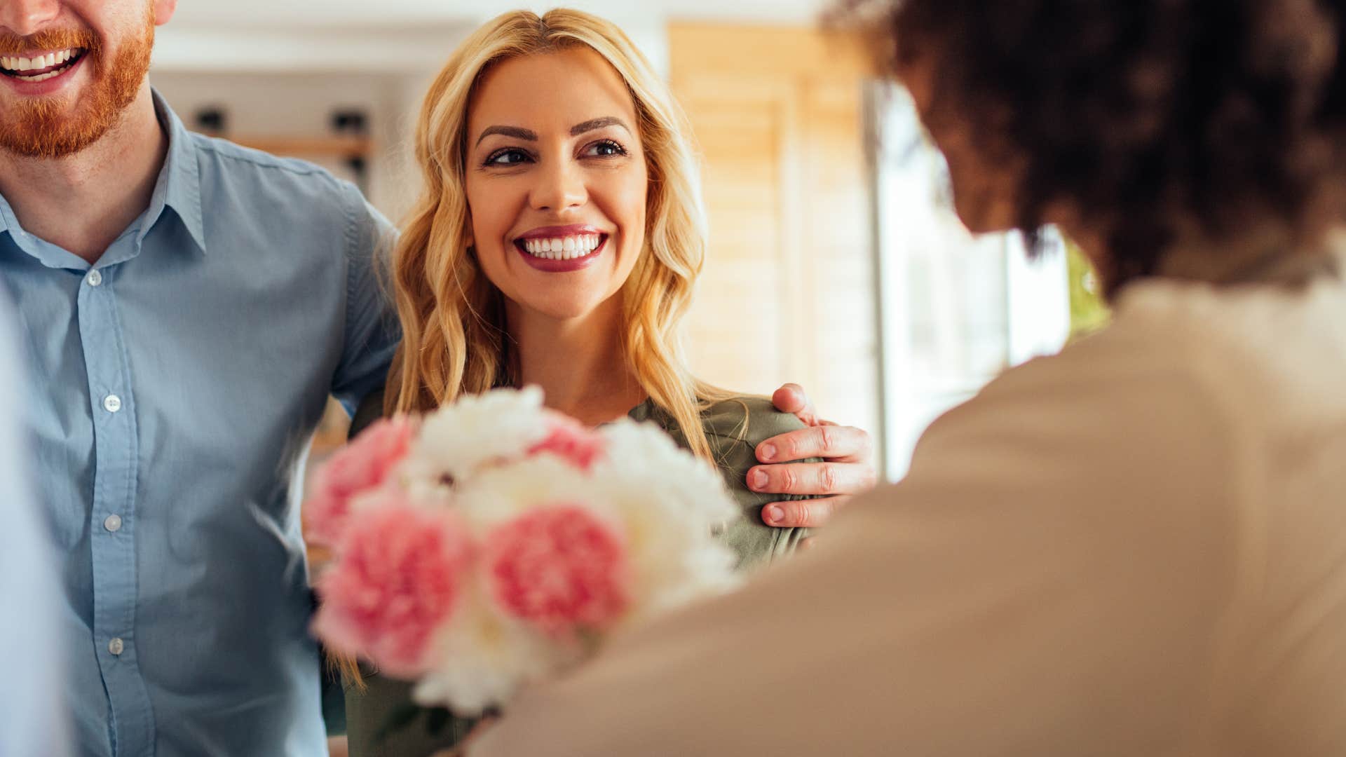 woman smiling bringing gift for a host