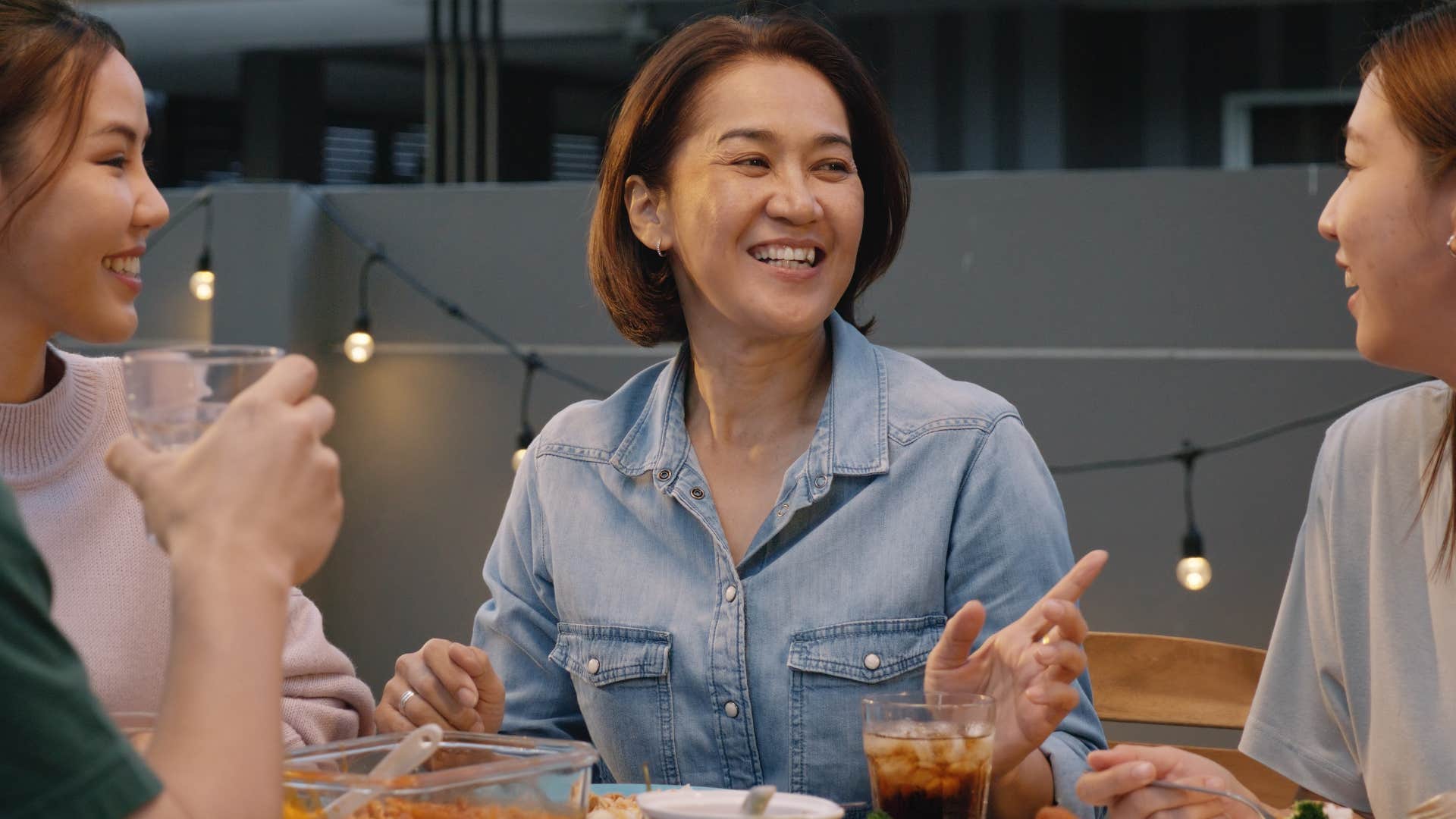 woman disconnected from her phone at dinner with friends