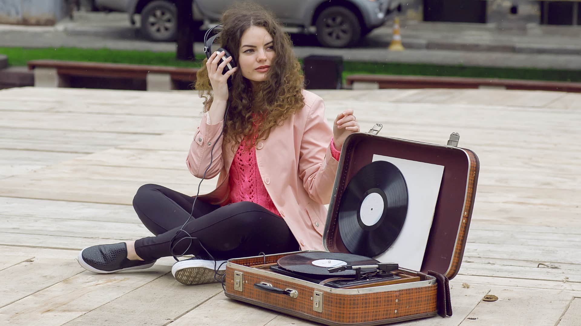 Woman listens to vinyl record not inside