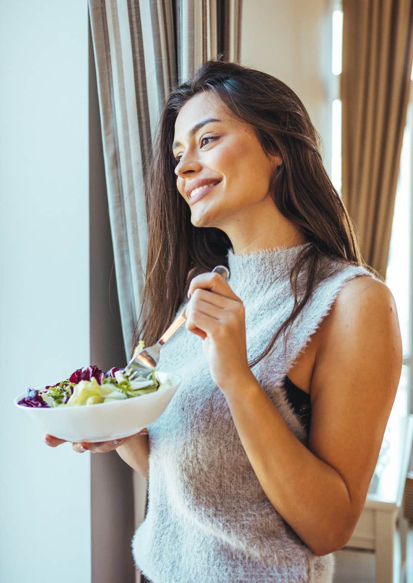 achievement-oriented woman eating vegetarian dish