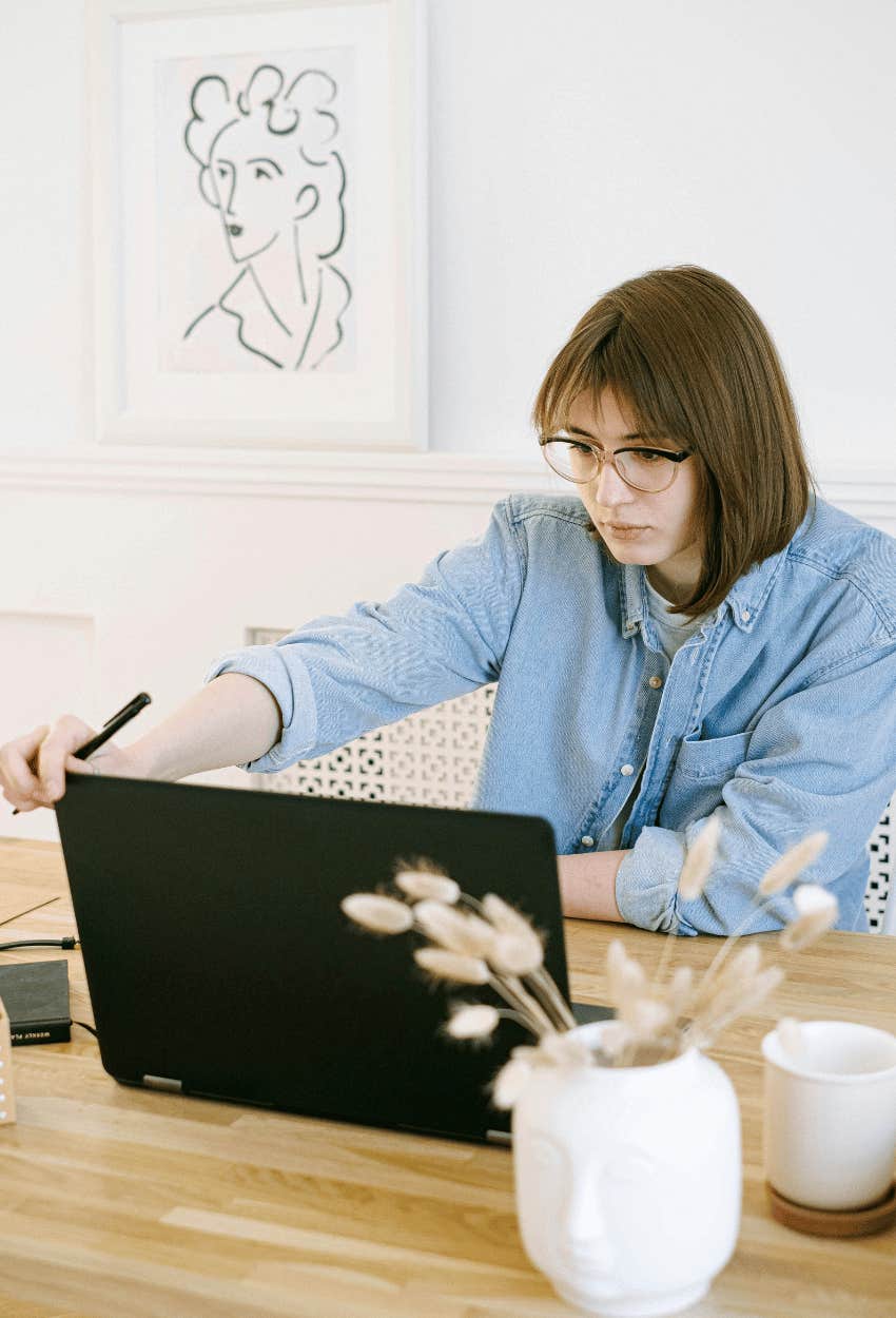 woman on laptop adding details to email