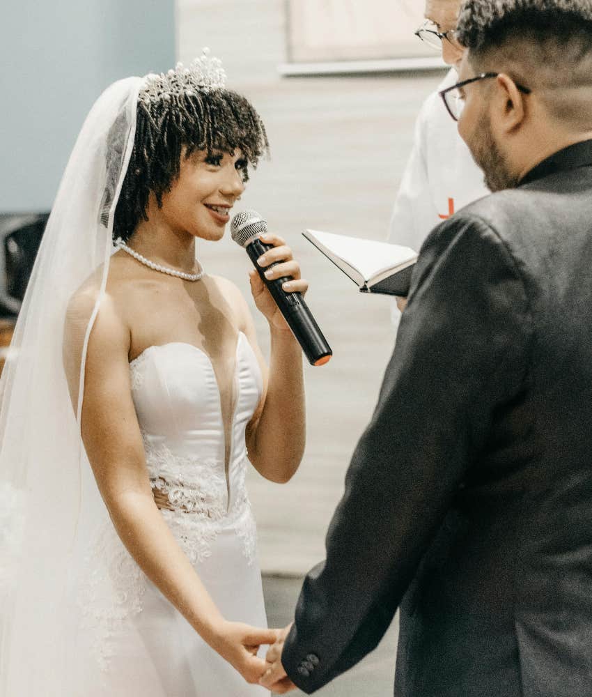 bride giving a speech with the groom