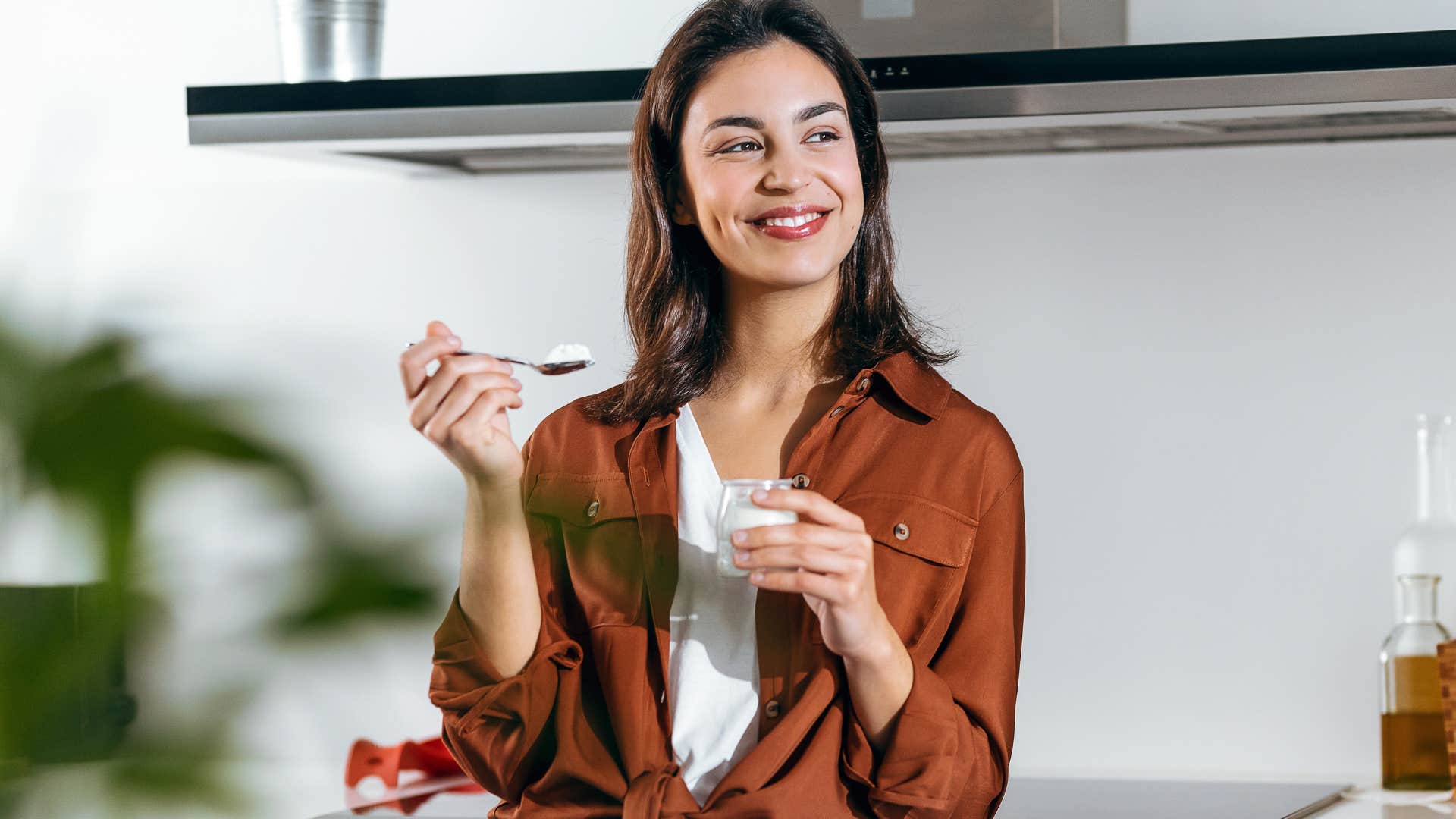 woman avoiding waste by eating in her kitchen