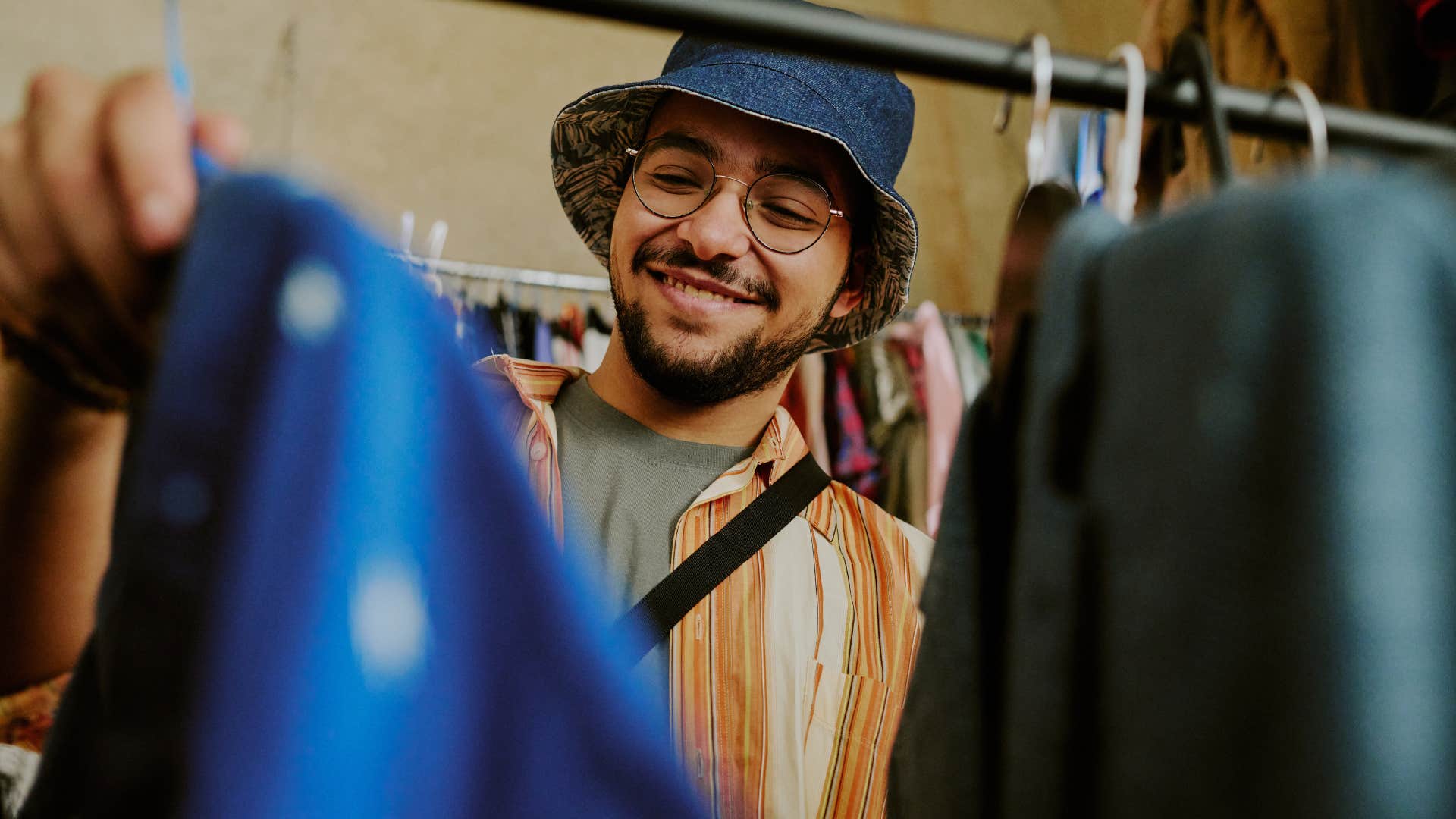 man shopping from the sale rack in a clothing store