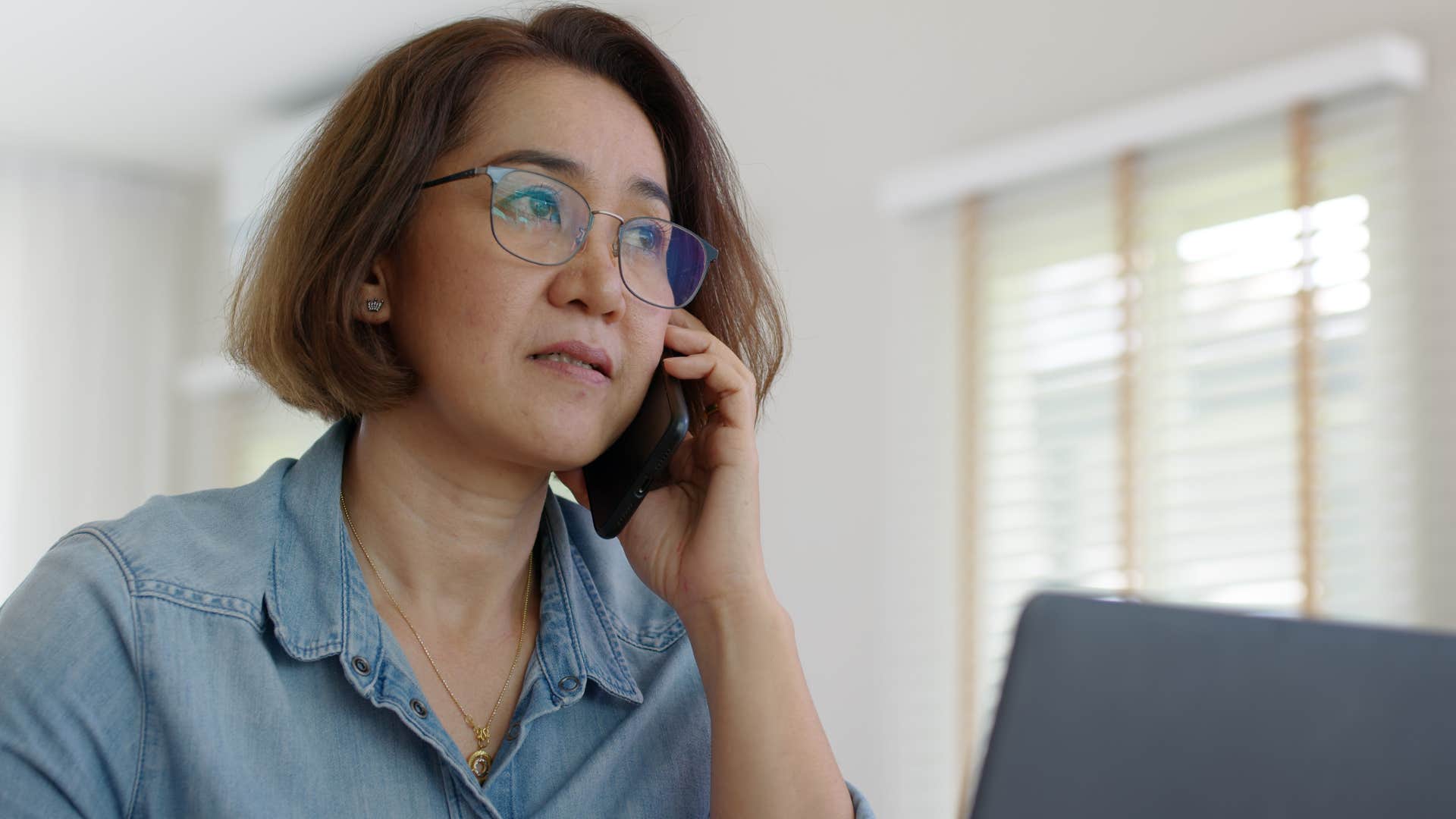 woman saying I'm too busy on the phone at work